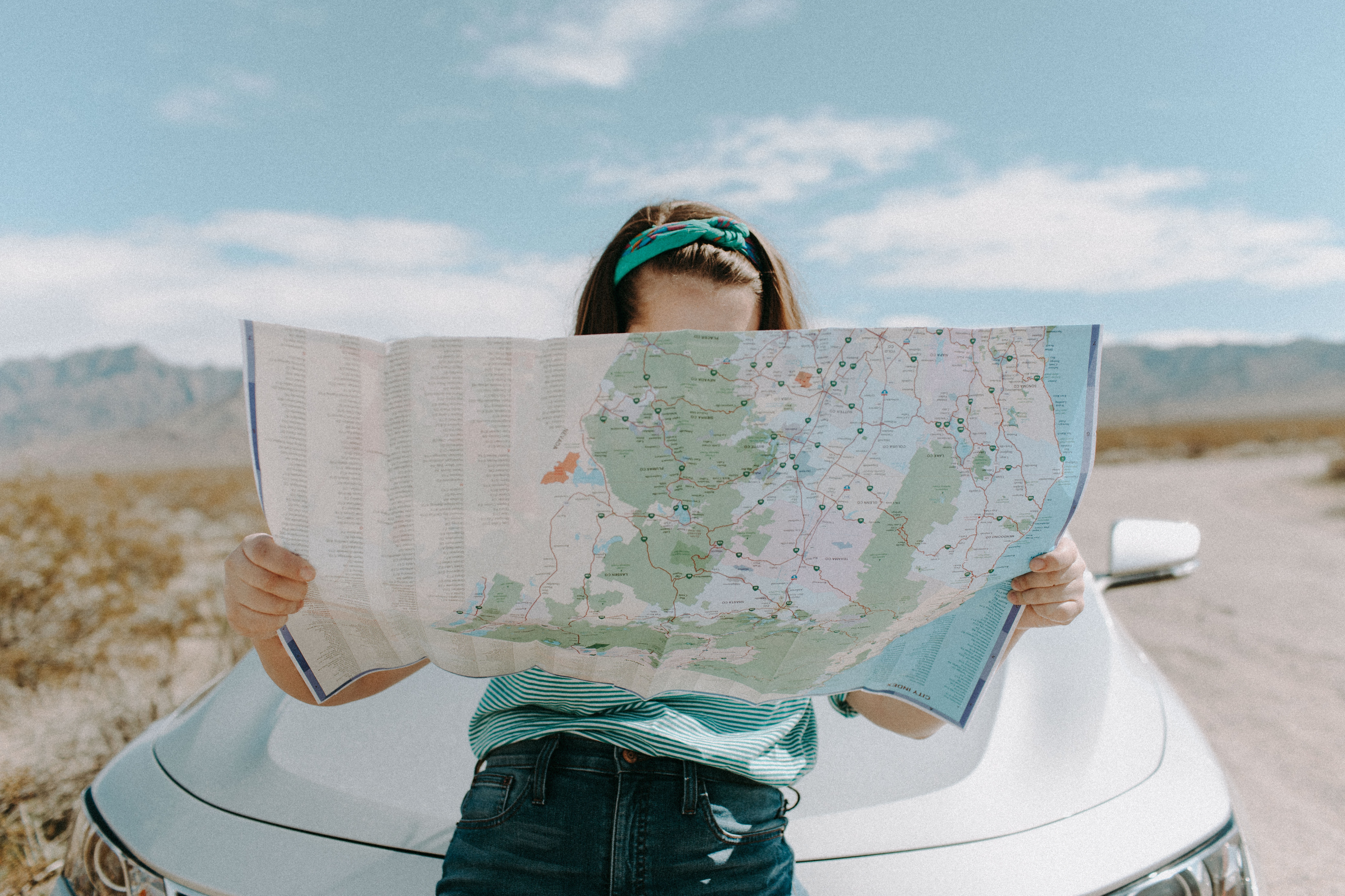A woman looking at a map. │Source: Pexels