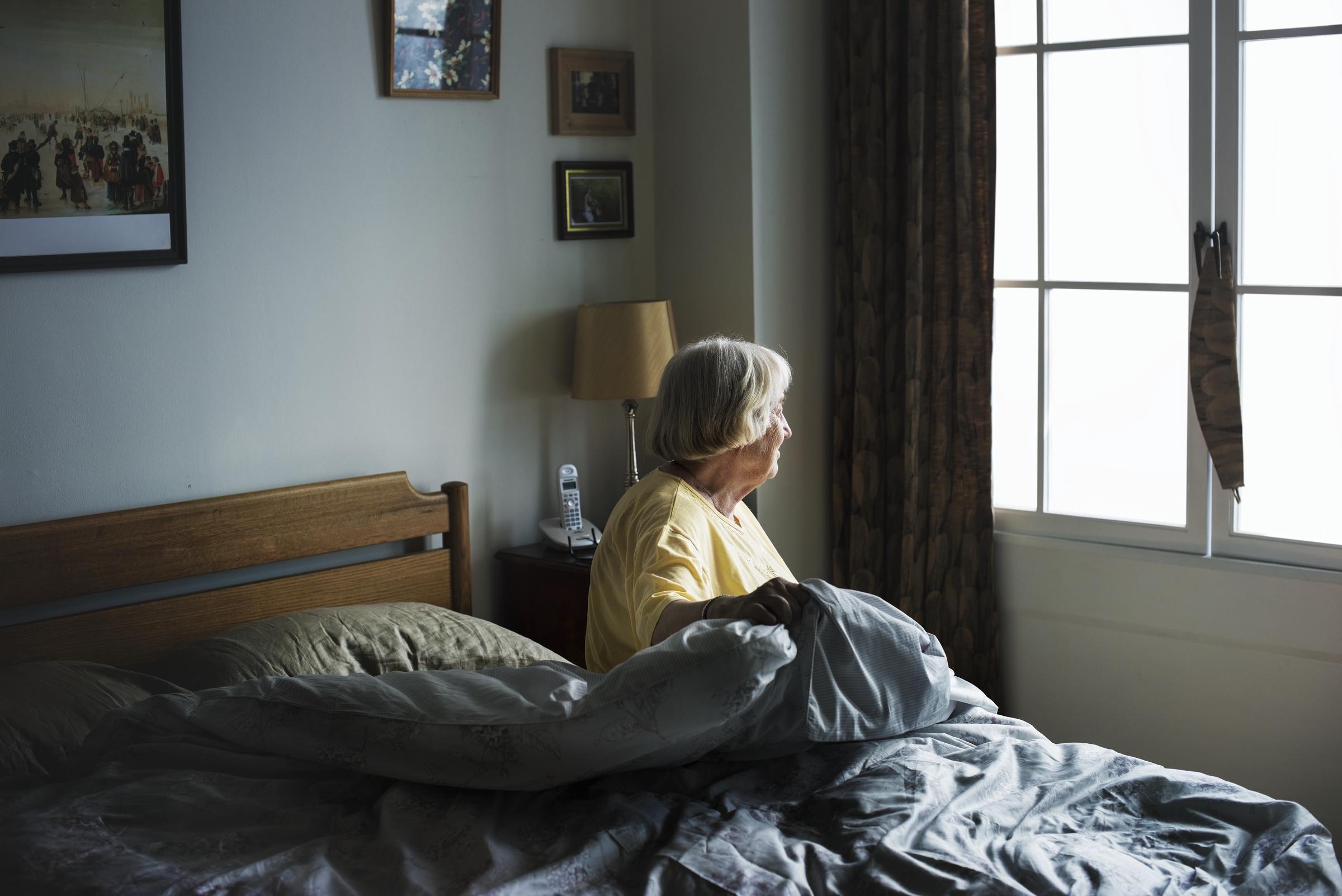 An elderly woman in her bedroom | Source: Freepik