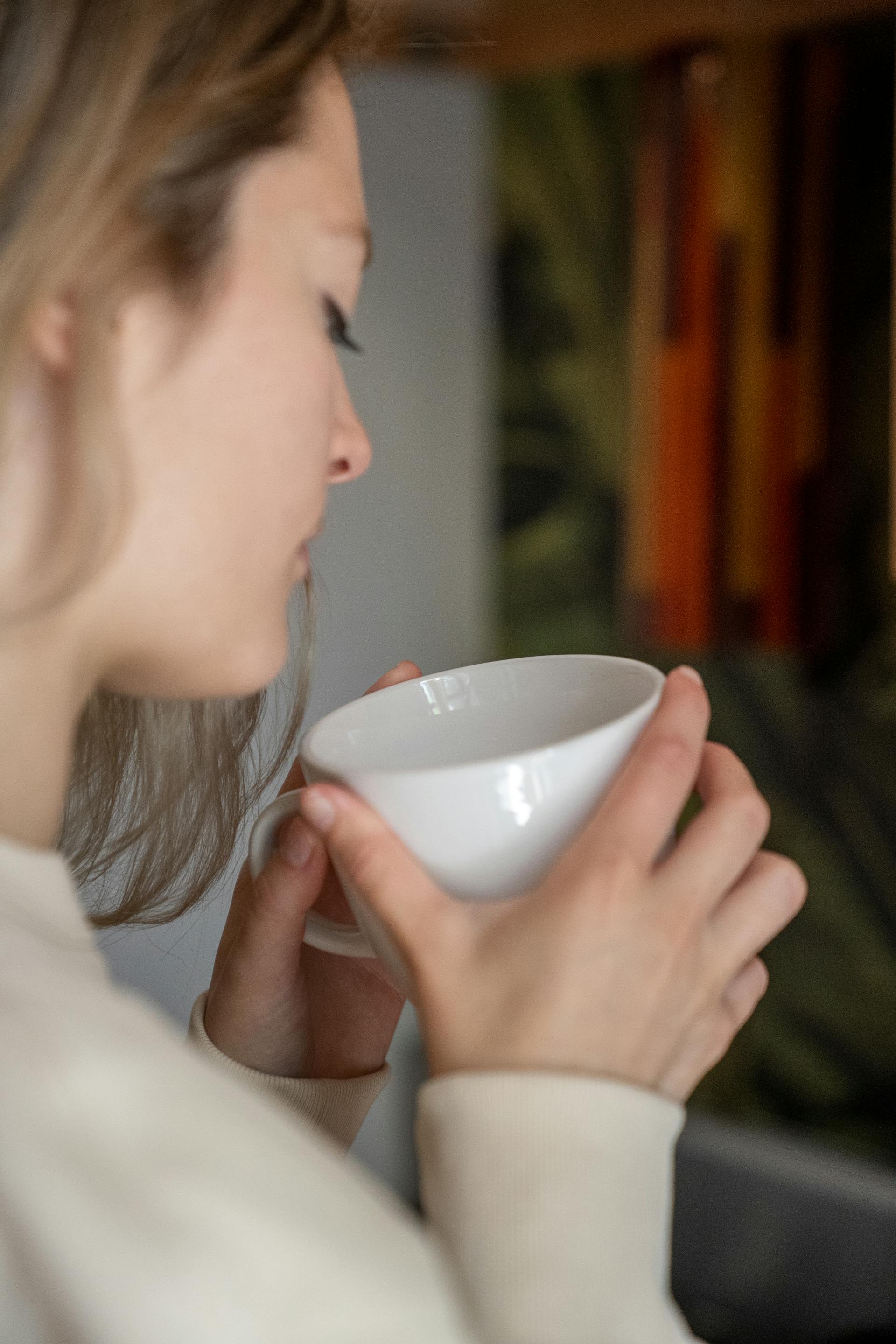A woman holding a white mug | Source: Pexels
