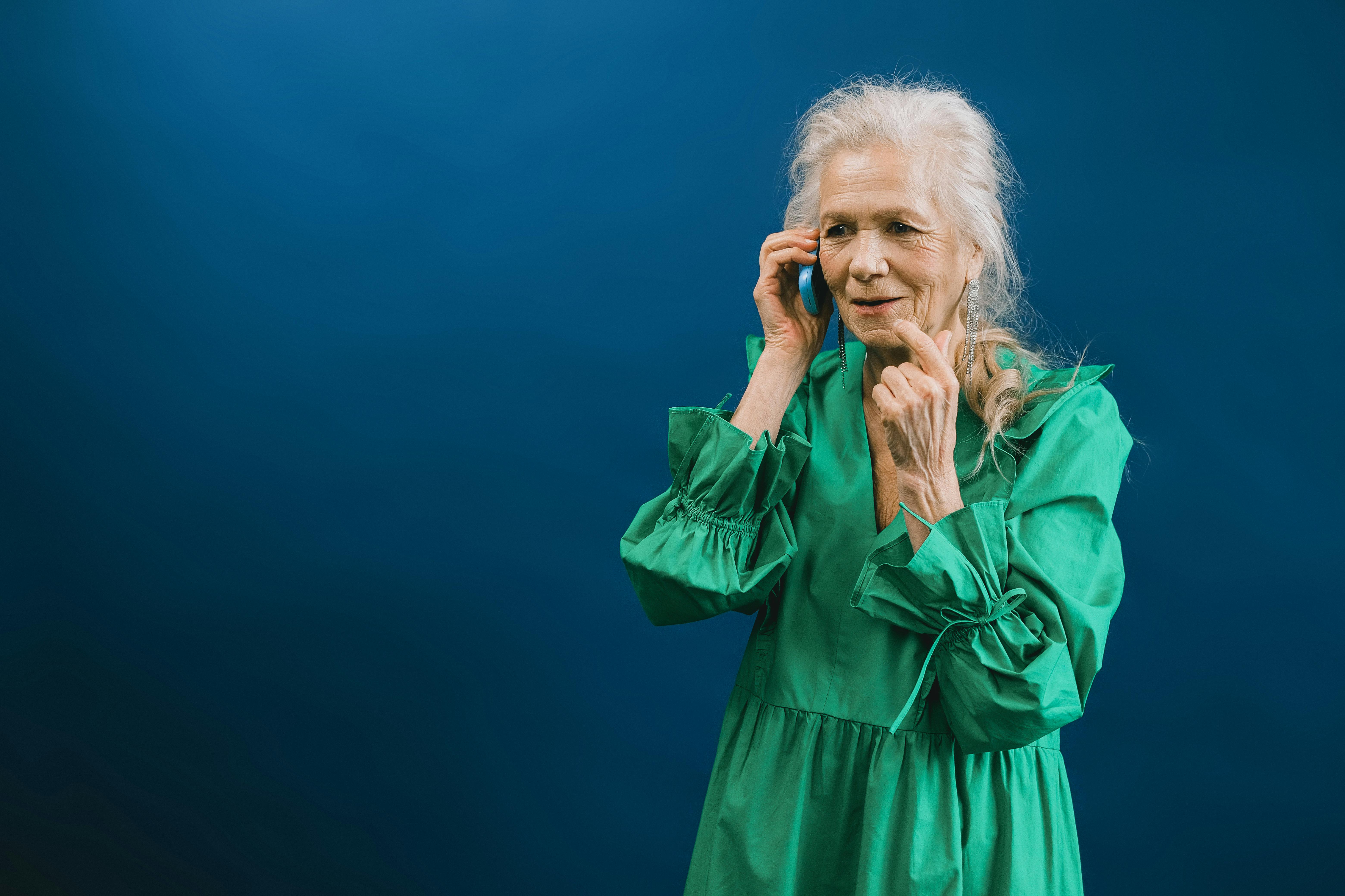 A smiling elderly woman on her phone | Source: Pexels