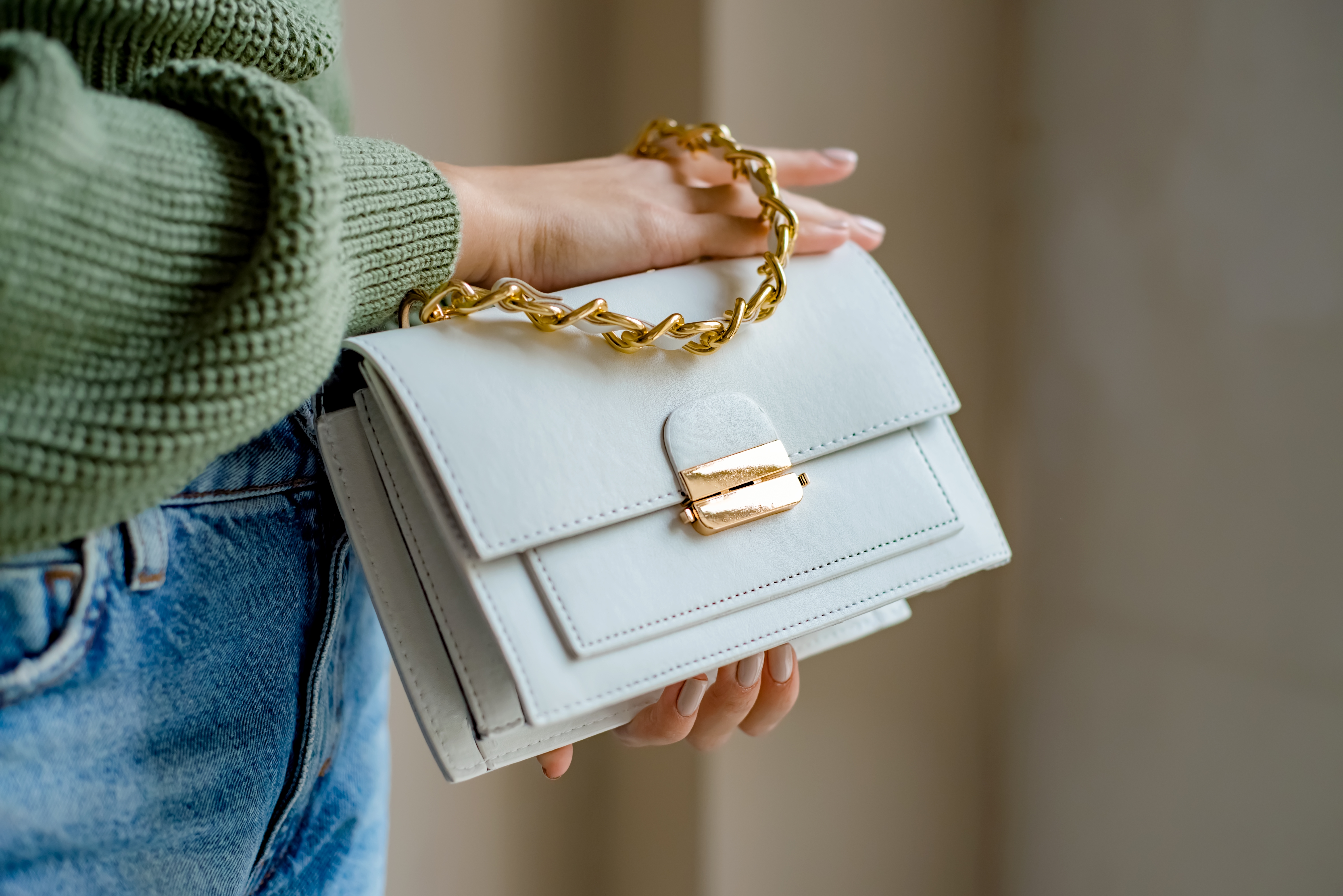 A woman holding a white handbag | Source: Shutterstock