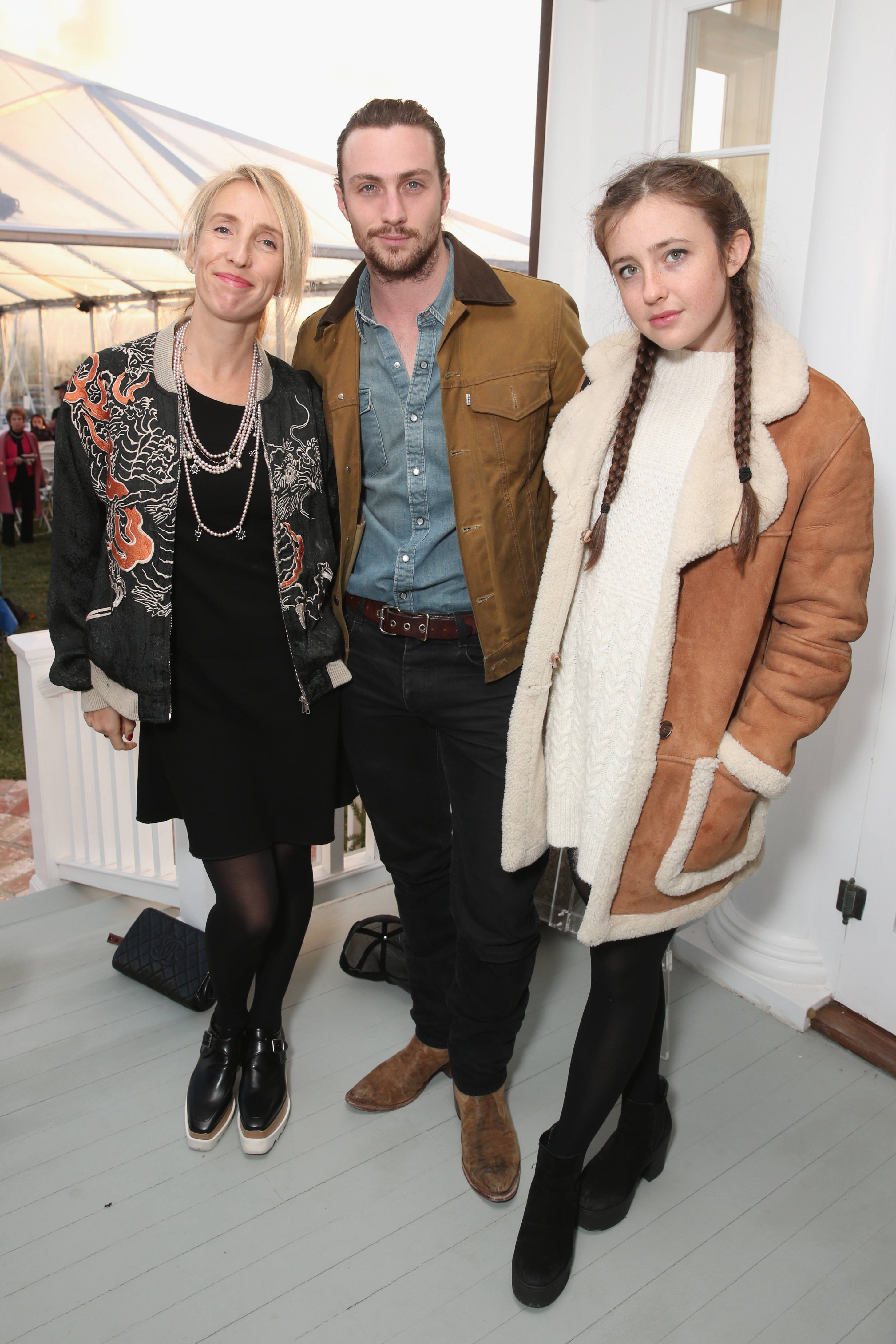 Sam Taylor-Johnson, Aaron Taylor-Johnson, and Wylda Johnson attend Rock4EB! 2015 with Ed Sheeran and David Spade in Malibu, California, on November 15, 2015 | Source: Getty Images