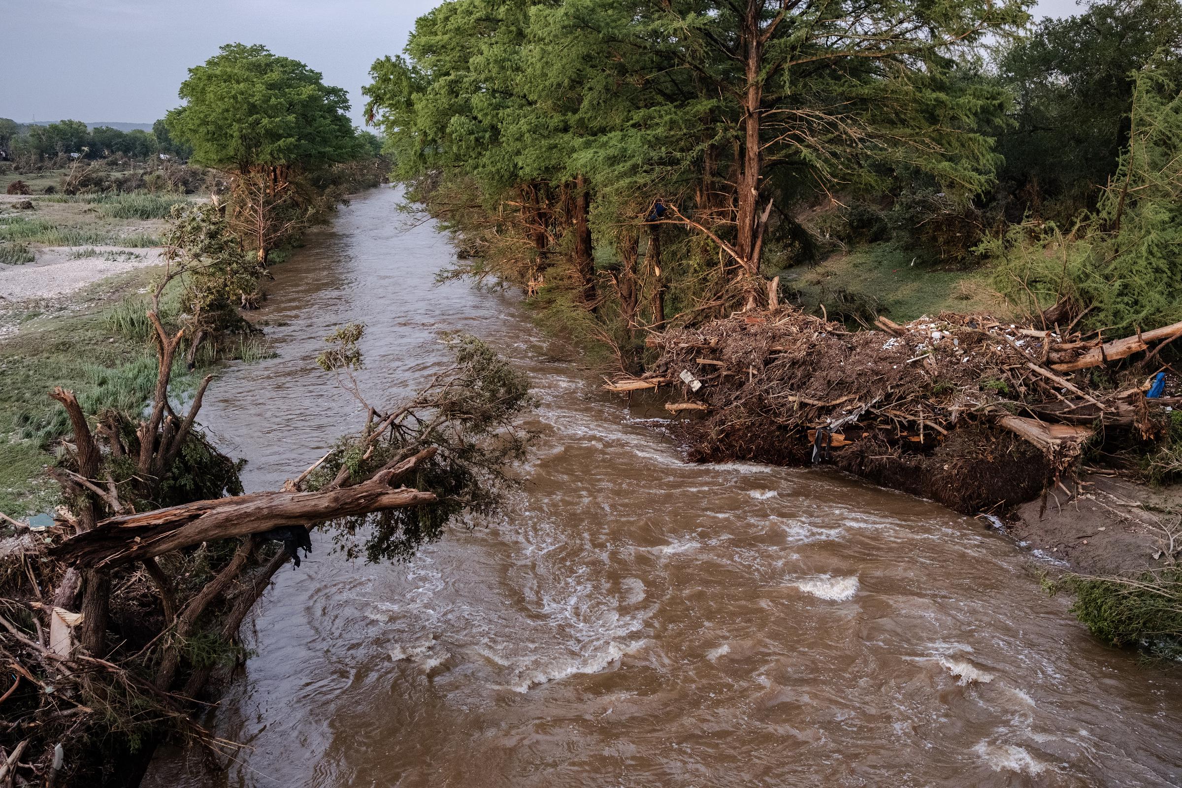 Damaged trees and debris lay on the bank Guadalupe River on July 5, 2025, in Center Point, Texas. | Source: Getty Images