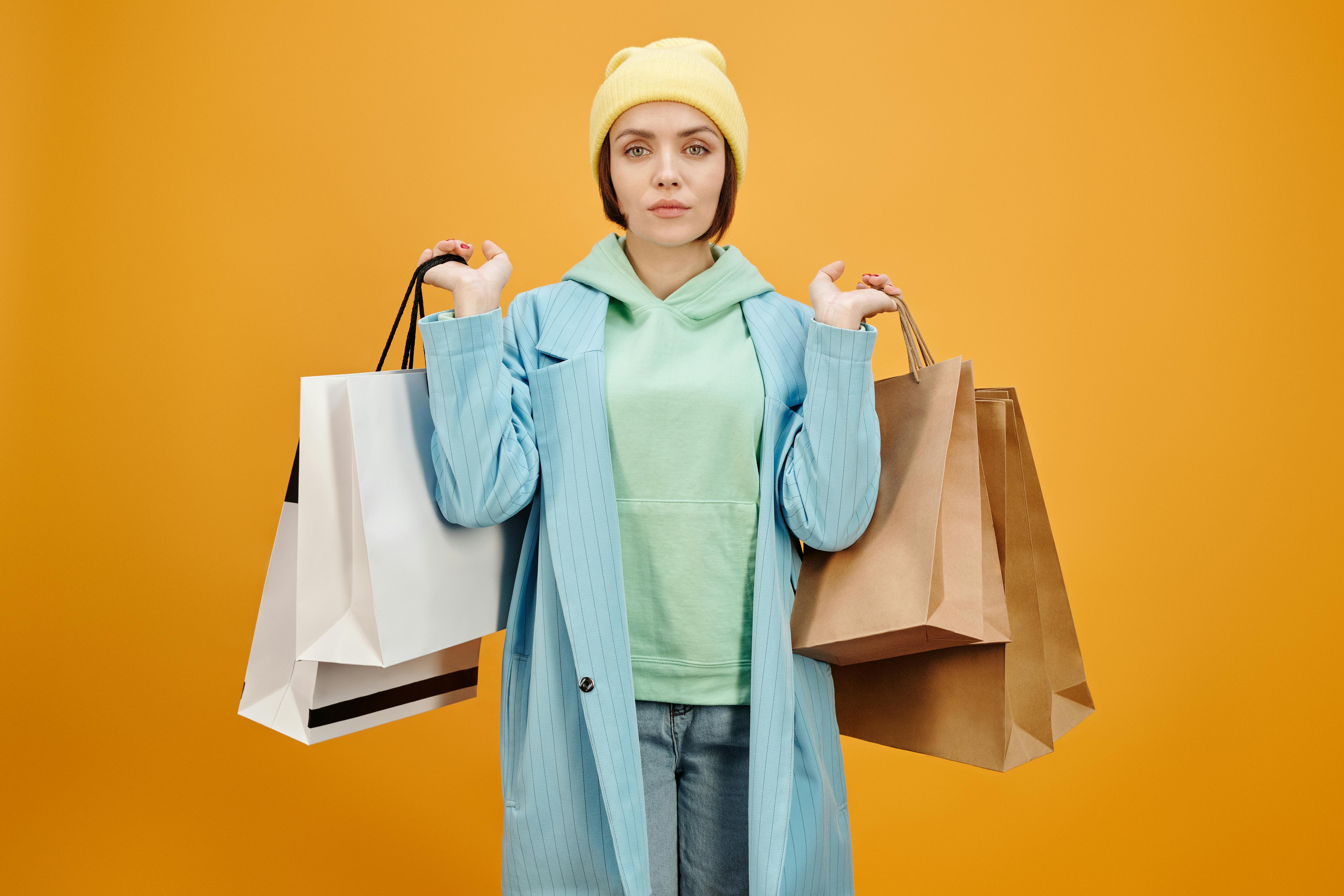 A woman holding shopping bags. | Source: Pexels