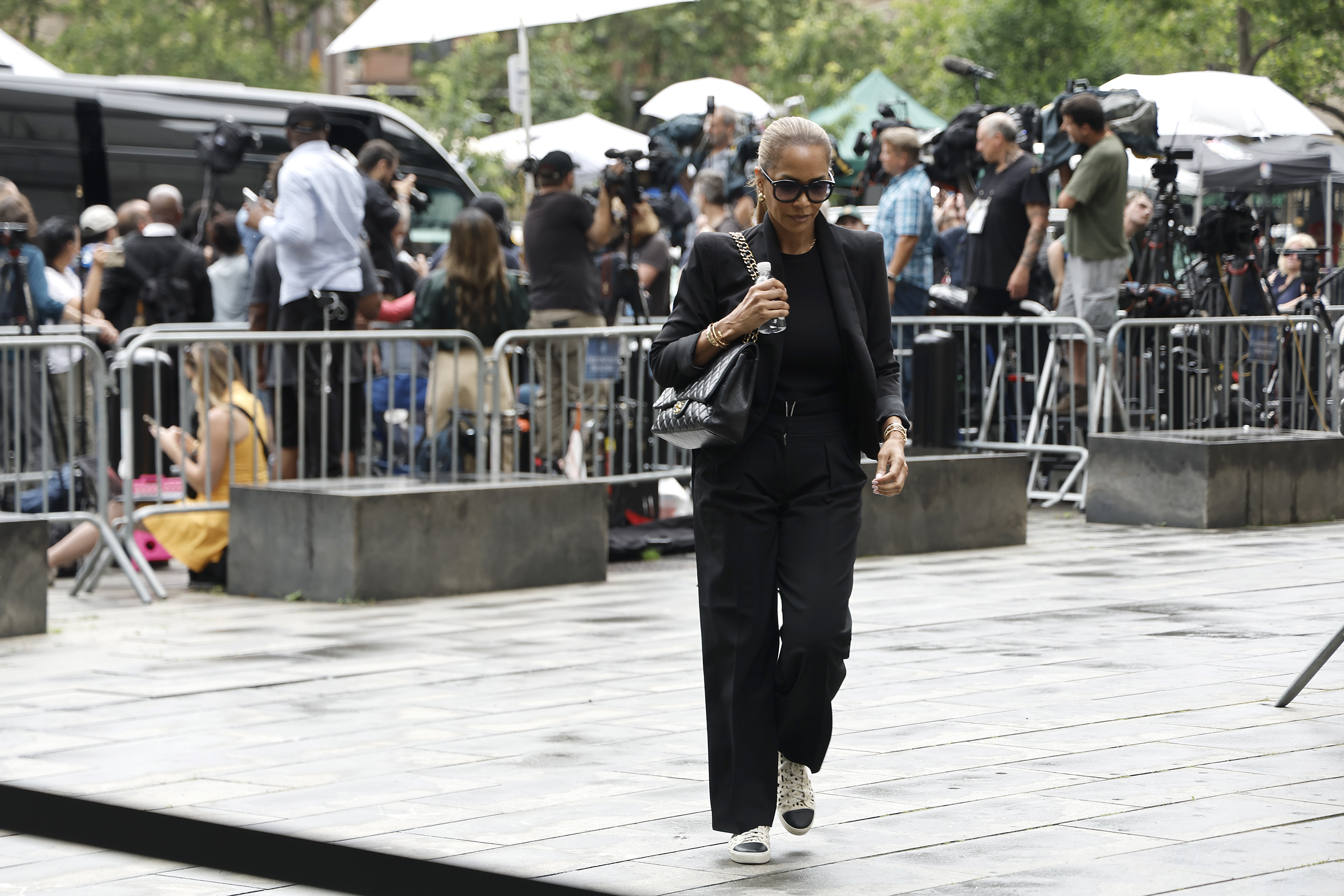 Sarah Chapman arrives at Manhattan Federal Court on July 2. Dressed in black and wearing dark sunglasses, she appears to walk briskly, avoiding the gaze of nearby cameras.