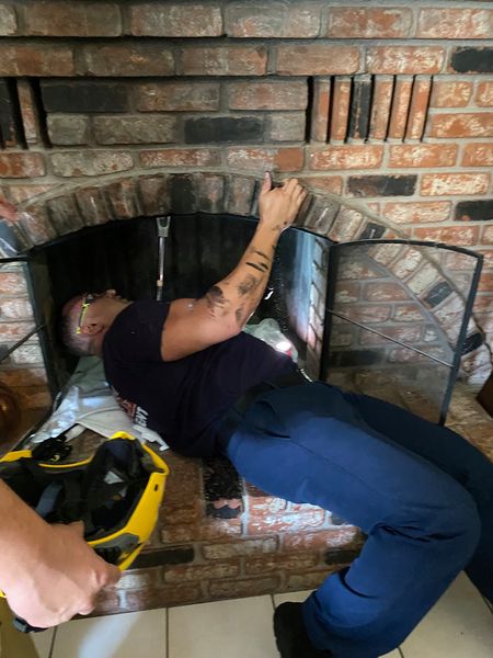 Fireman gets under the chimney to rescue stuck 18-year-old. | Source: Facebook/ Henderson Fire Department