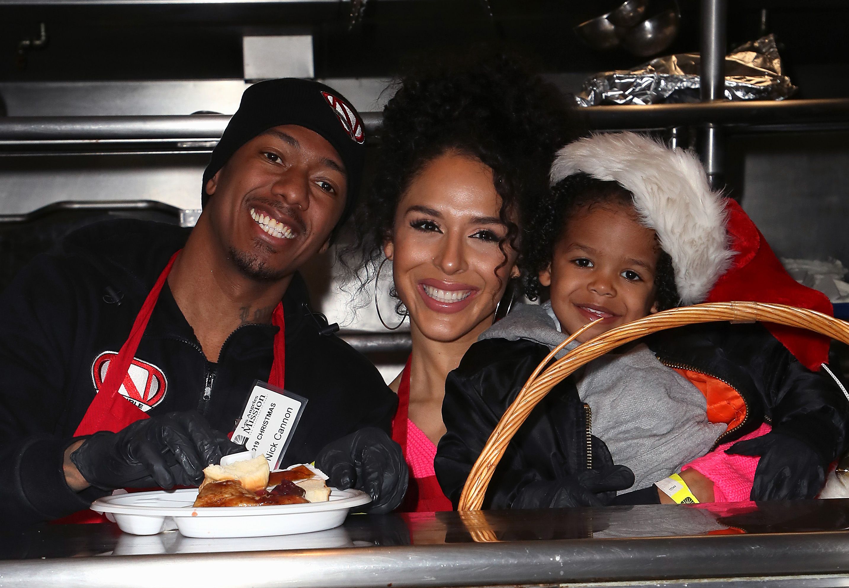 Nick Cannon, Brittany Bell, and their son Golden Cannon at the Christmas Celebration On Skid Row at the Los Angeles Mission on December 23, 2019. | Photo: Getty Images 