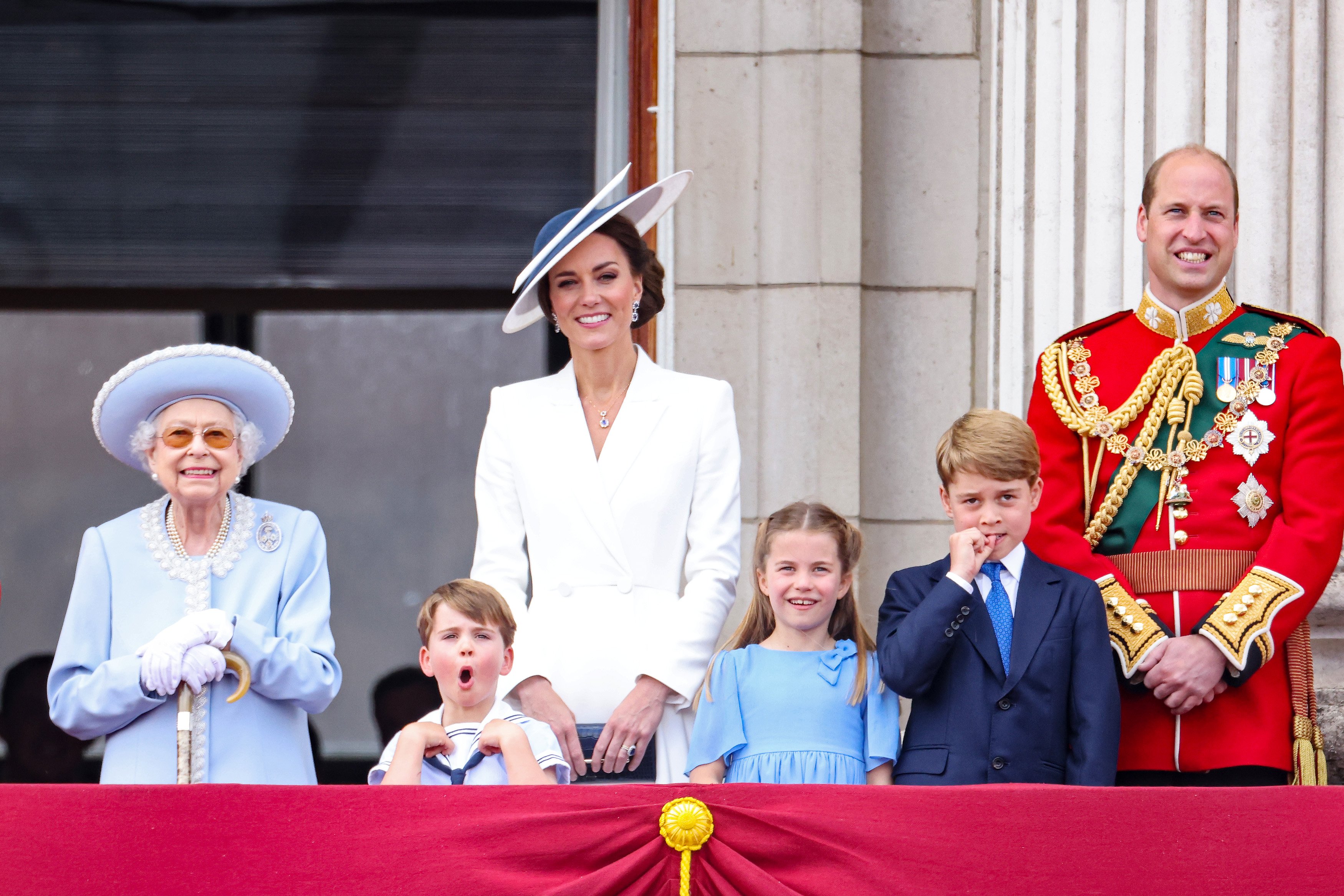 Queen Elizabeth II, Prince Louis, Catherine, Duchess of Cambridge, Princess Charlotte, Prince George, and Prince William watch the RAF flypast on the balcony of Buckingham Palace during the Trooping the Colour parade on June 02, 2022, in London, England. | Source: Getty Images