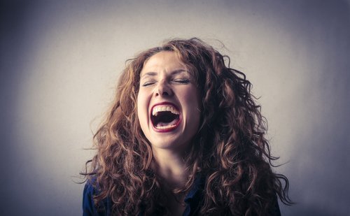 A woman laughing out loud. | Source: Shutterstock.