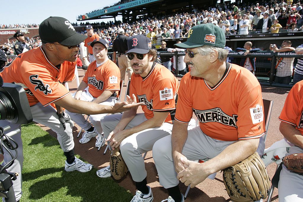 Jon Kelley of the American League Legends talks with Marcus Giamatti and Rollie Fingers during the Taco Bell All-Star Legends & Celebrity Softball Game  | Getty Images