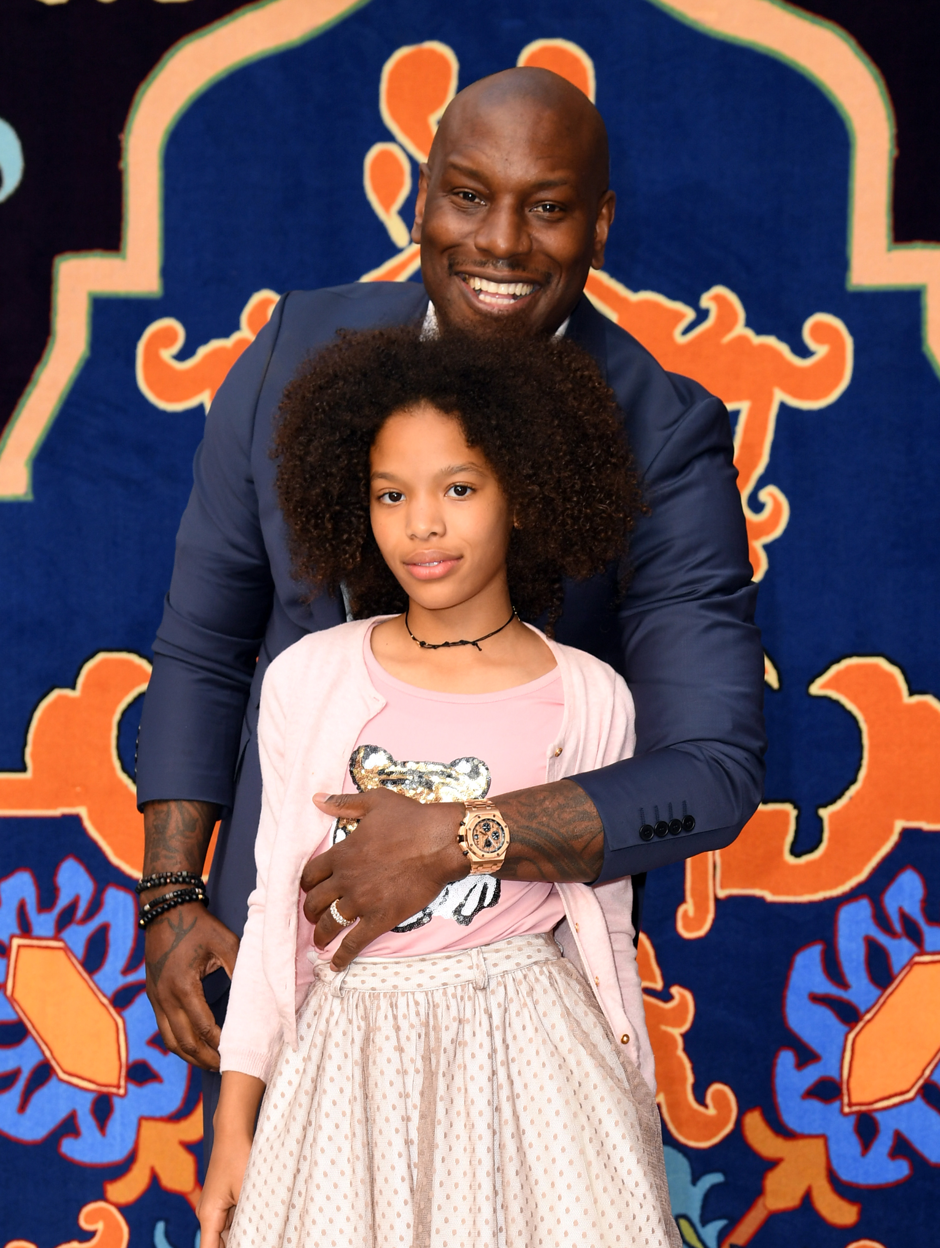 Tyrese Gibson wrapped his arm around Shayla Gibson as the father-daughter duo posed against a vibrant backdrop at the star-studded Disney premiere. While Tyrese flashed his signature grin in a sharp blue suit, Shayla looked effortlessly poised in soft pink tones and a sparkling skirt.