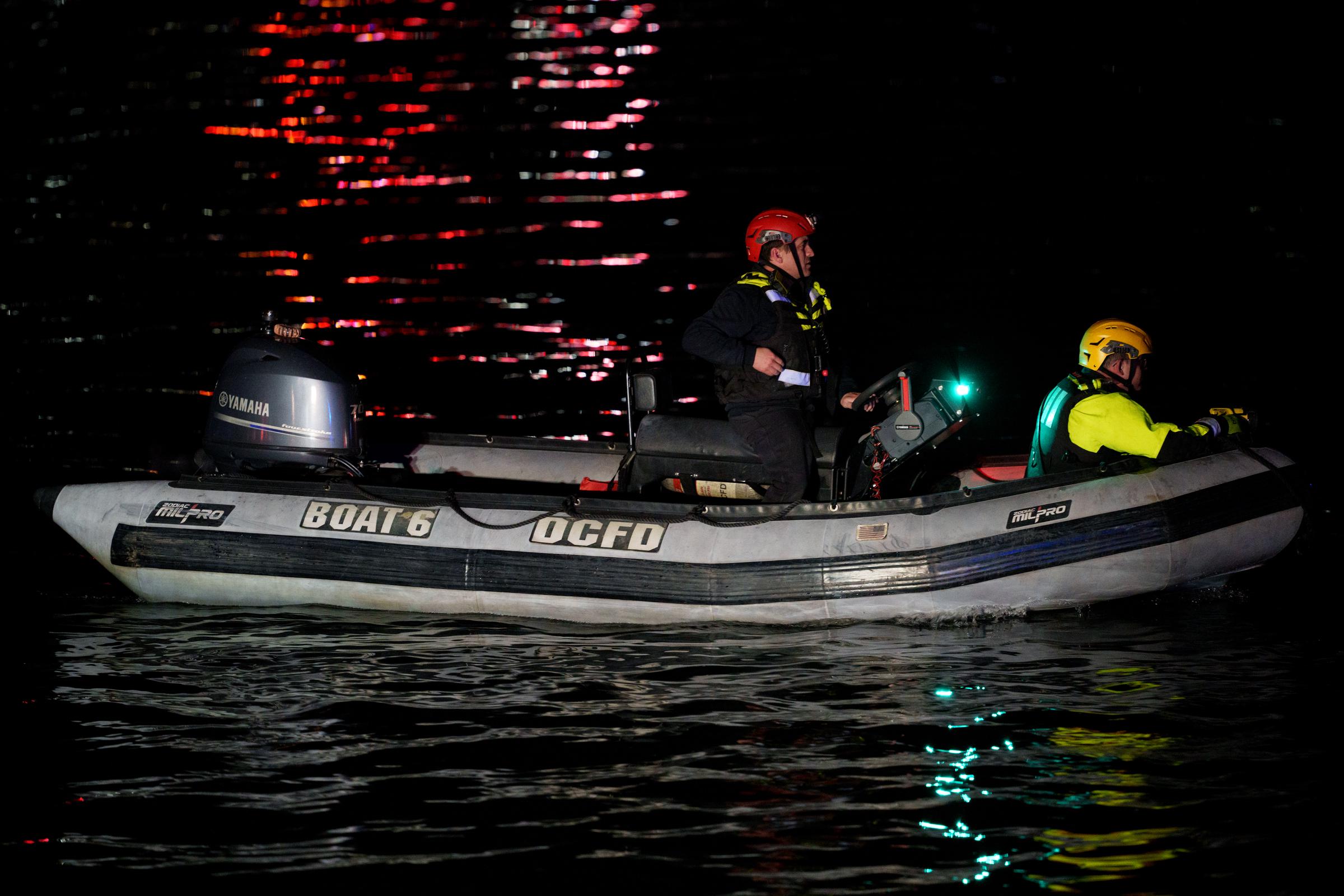 An emergency response team make their way to airplane wreckage in the Potomac River on January 30, 2025, in Arlington, Virginia. | Source: Getty Images