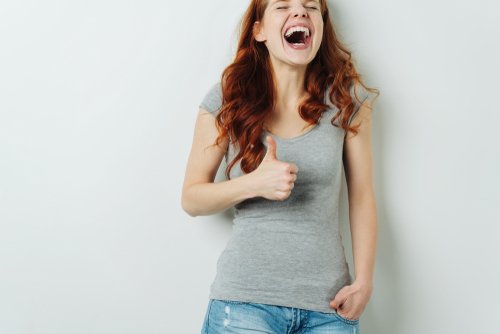 A young woman laughing out loud. | Source: Shutterstock