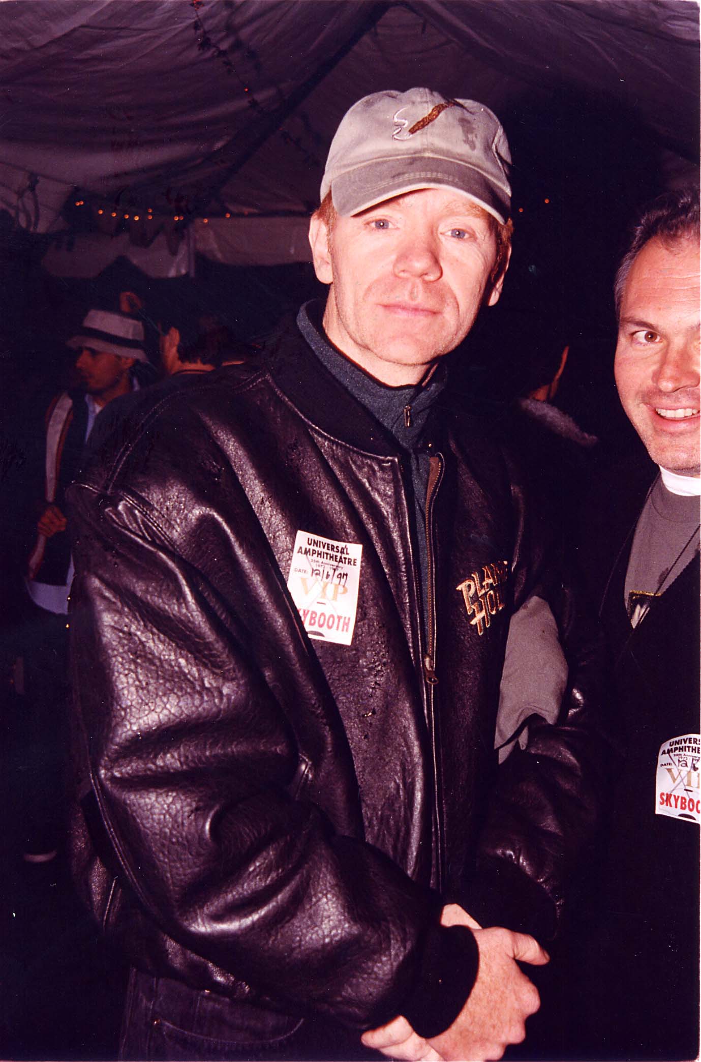 David Caruso keeps warm in a black leather jacket and gray cap during the KROQ Acoustic X-Mas event in Los Angeles, California, posing calmly amid the lively event crowd.