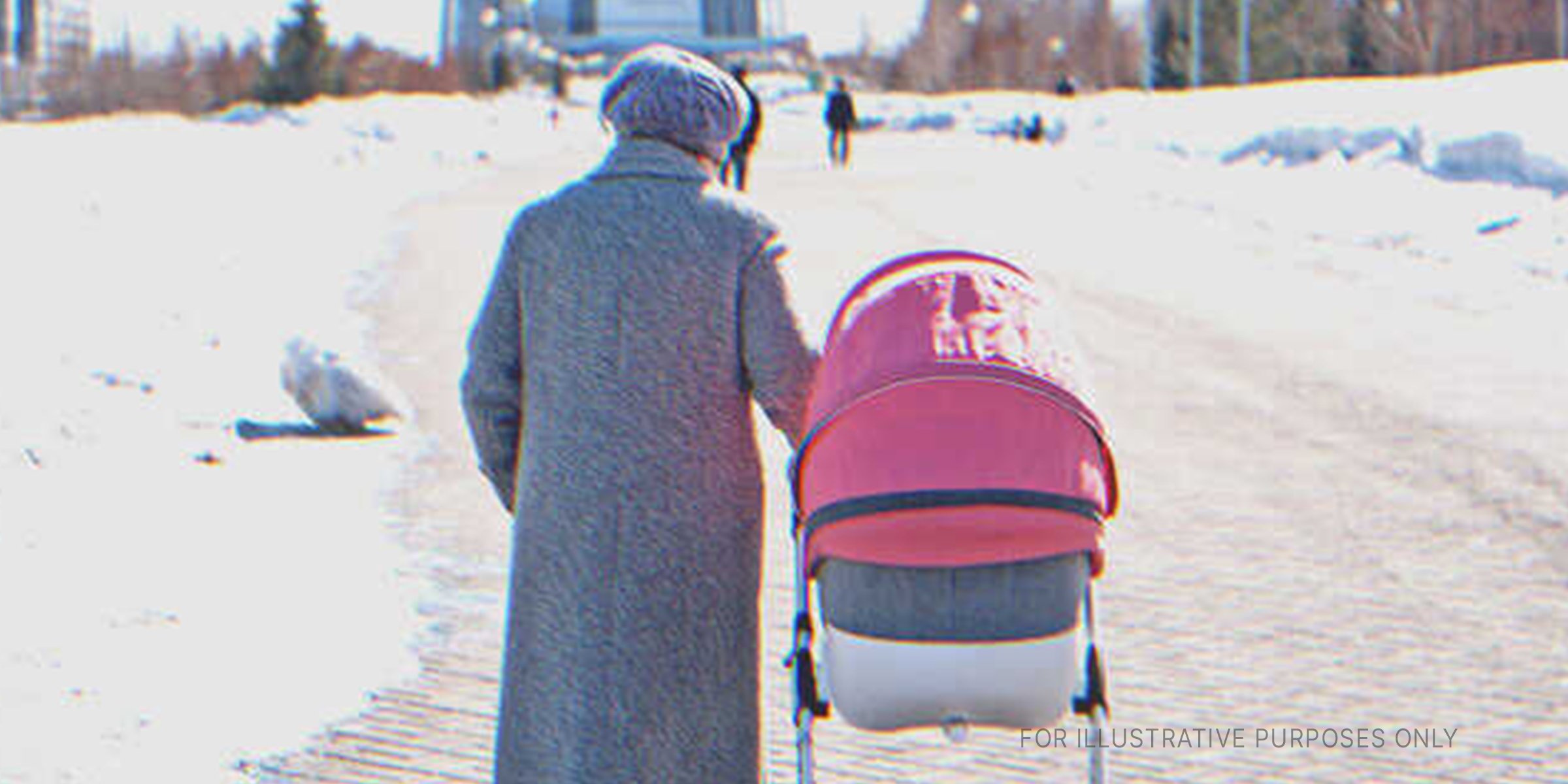 Person moving a stroller in the snow. | Source: Shutterstock