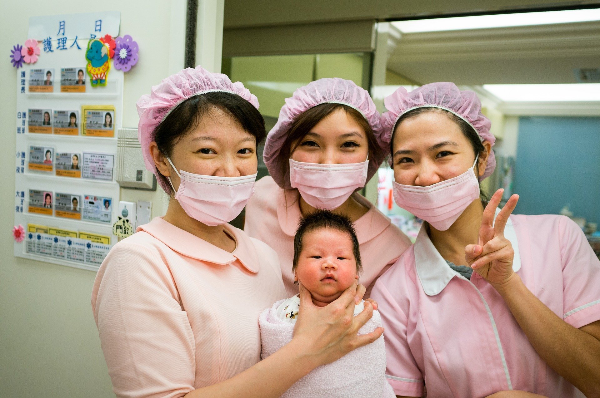 Nurses holding a baby. | Source: Pexels