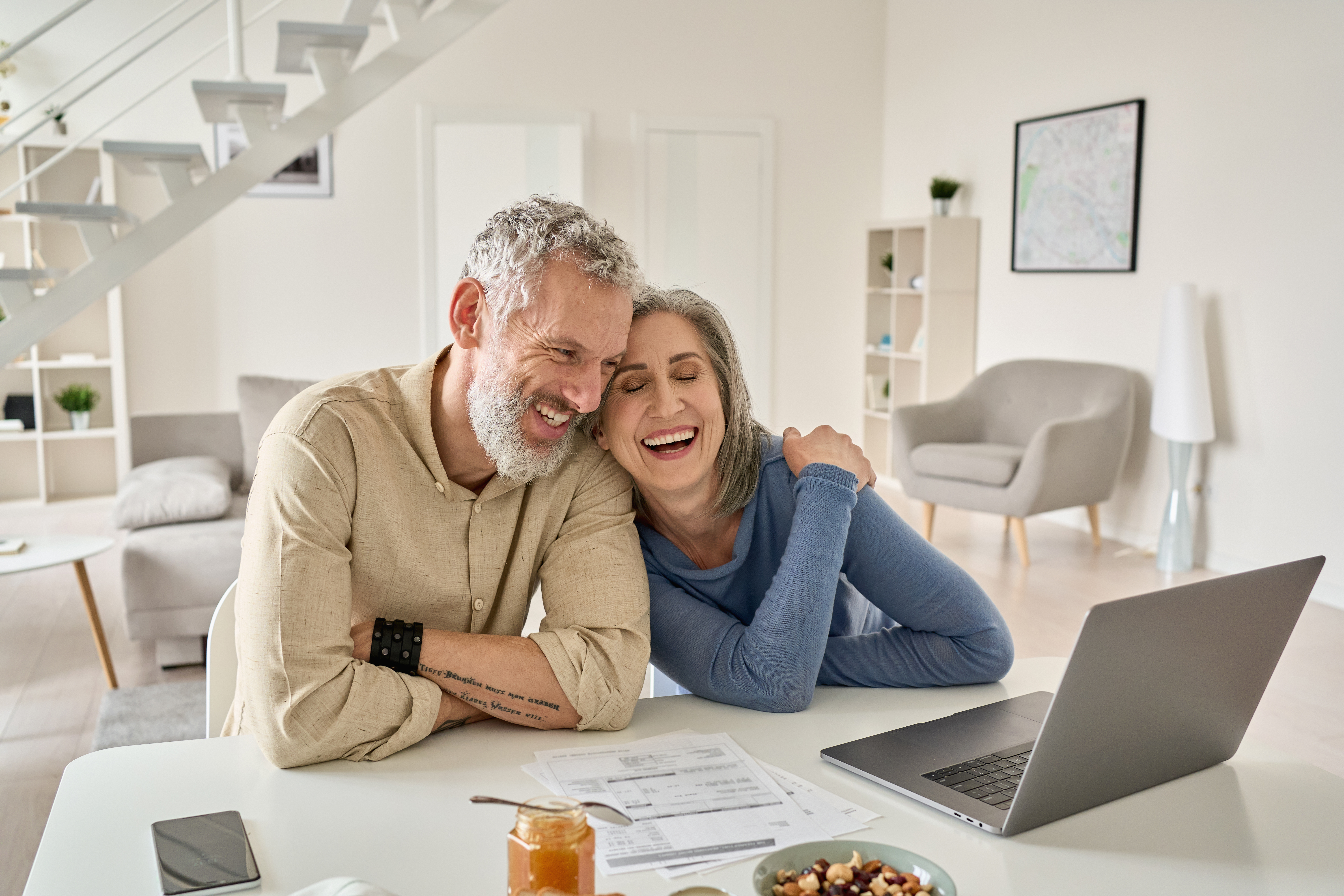 A middle-aged couple laughs | Source: Shutterstock
