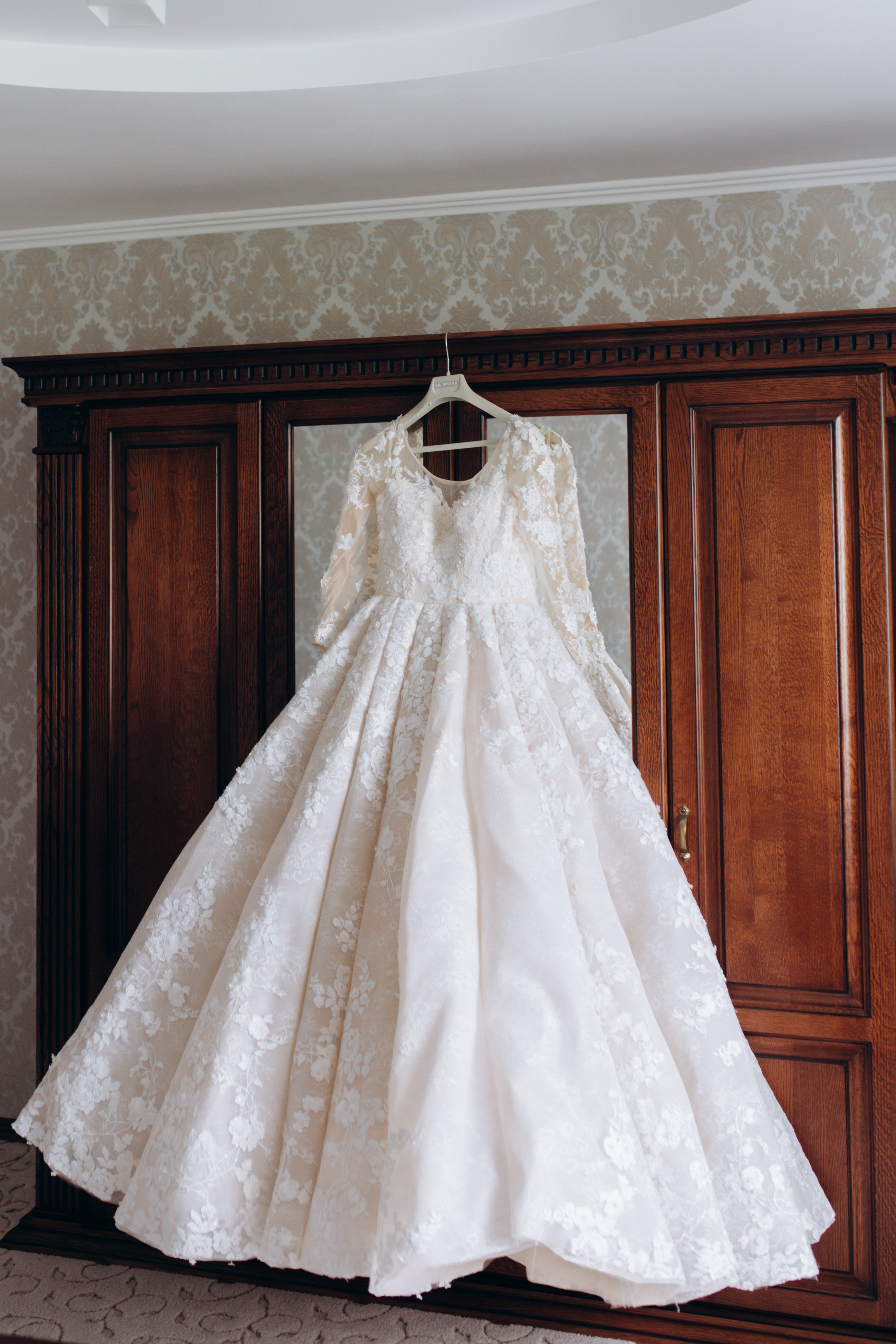 A bridal gown on the wardrobe | Source: Freepik