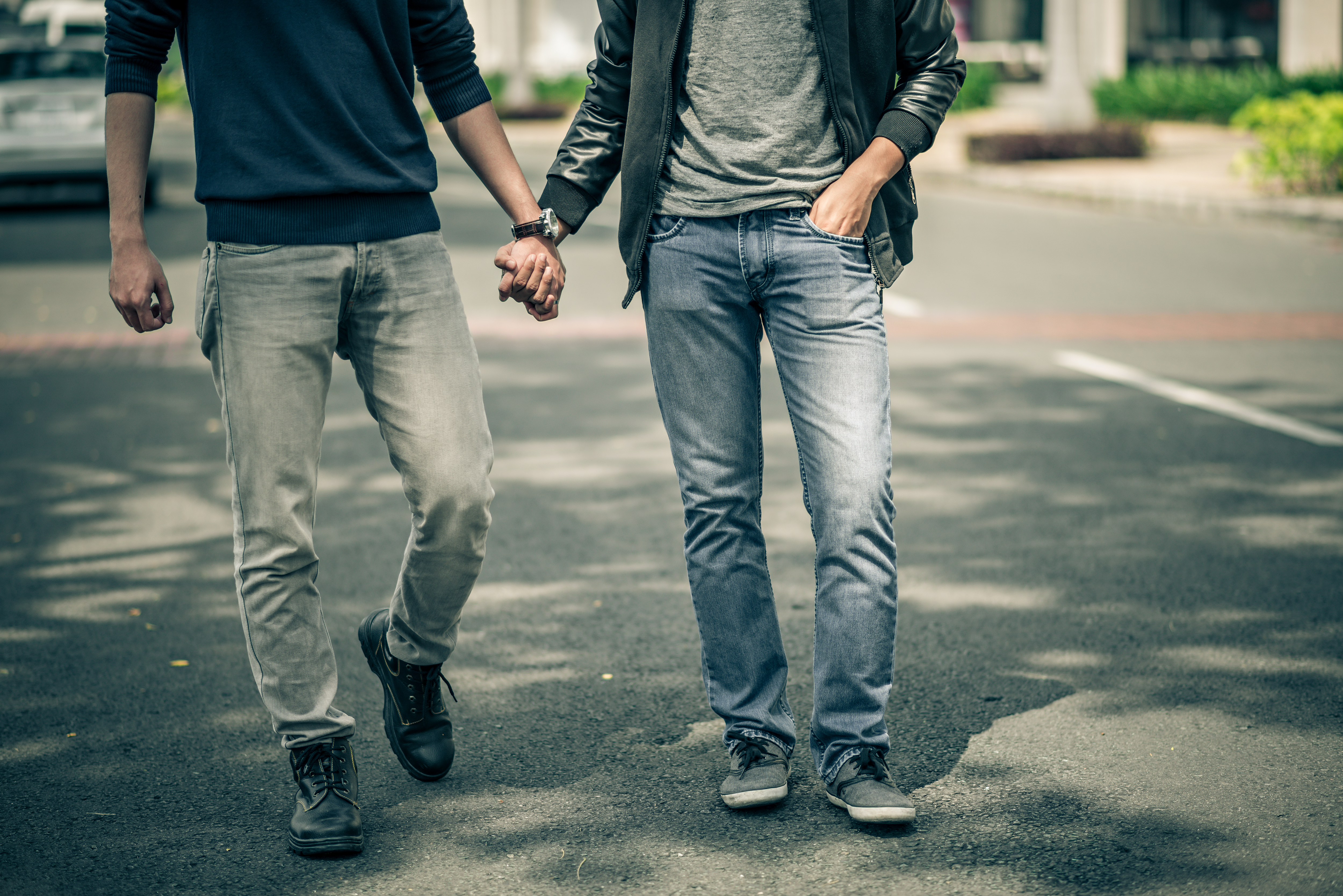Two men holding hands | Source: Shutterstock