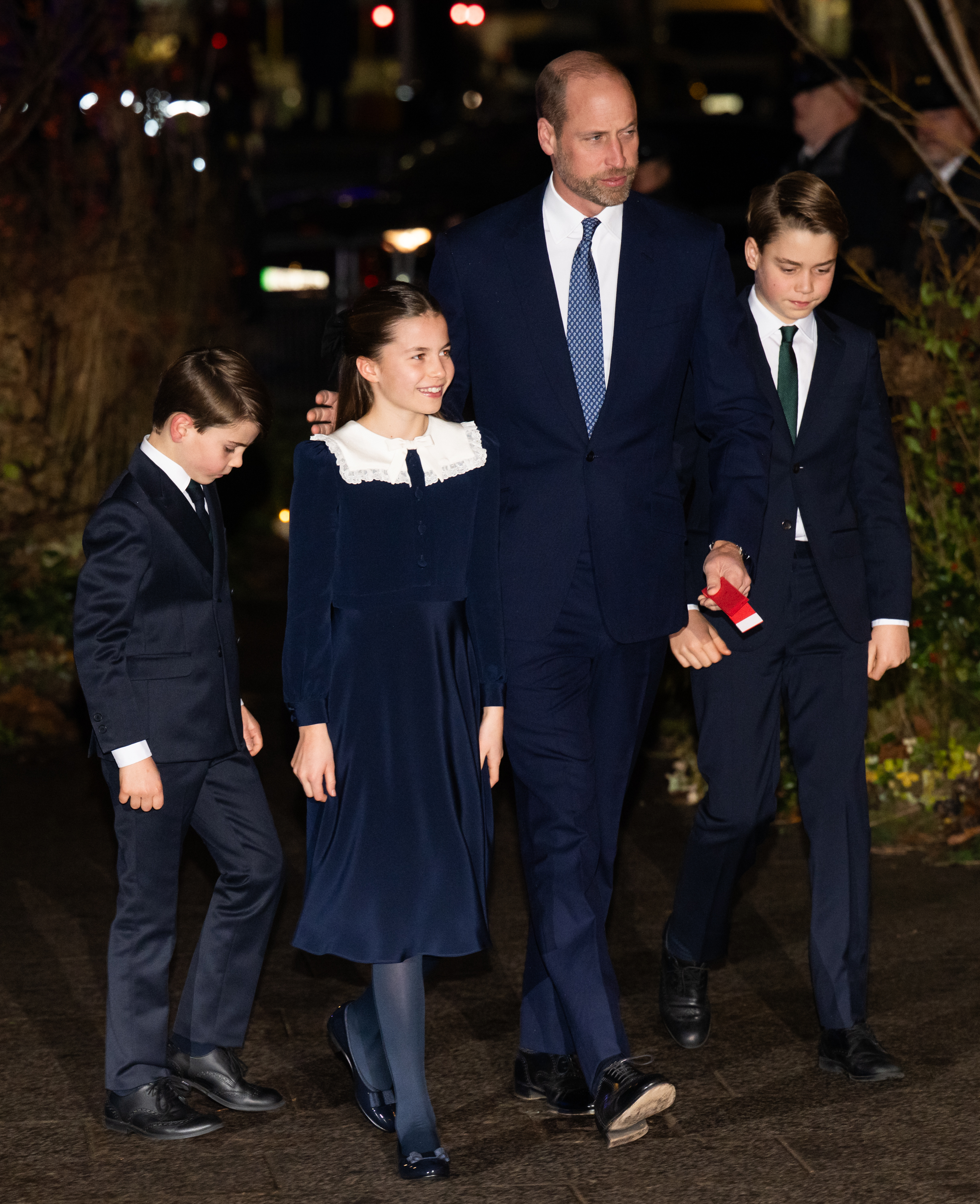 Prince Louis, Princess Charlotte, William, Prince of Wales, and Prince George arrive in coordinated navy looks for the "Together at Christmas" carol service at Westminster Abbey on December 5, 2025. The family's first joint outing in six months saw the young royals looking more grown up than ever, walking confidently alongside their father in a rare public appearance.