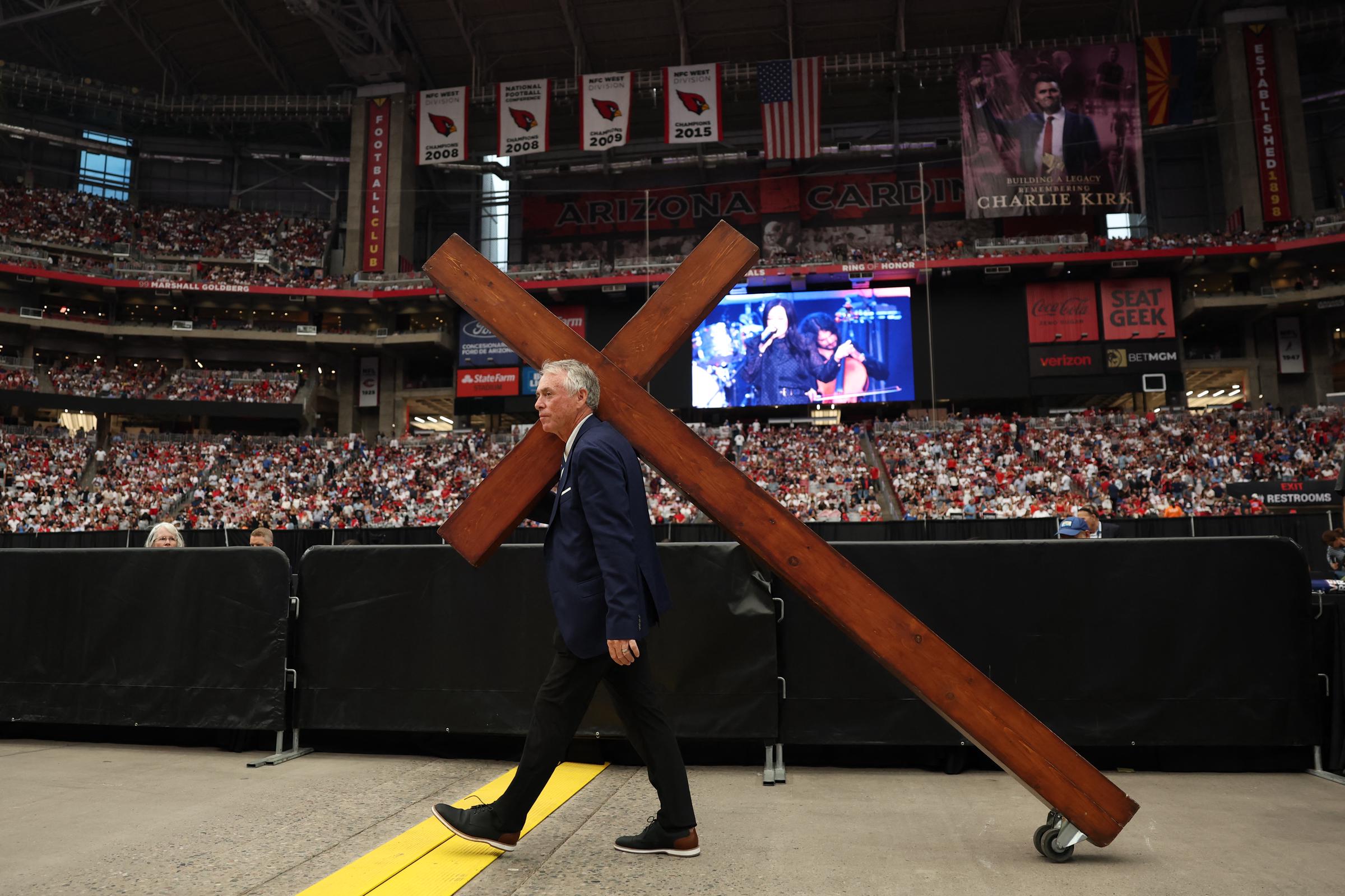A large cross is wheeled in ahead of the public memorial service on September 21, 2025 in Glendale, Arizona | Source: Getty Images