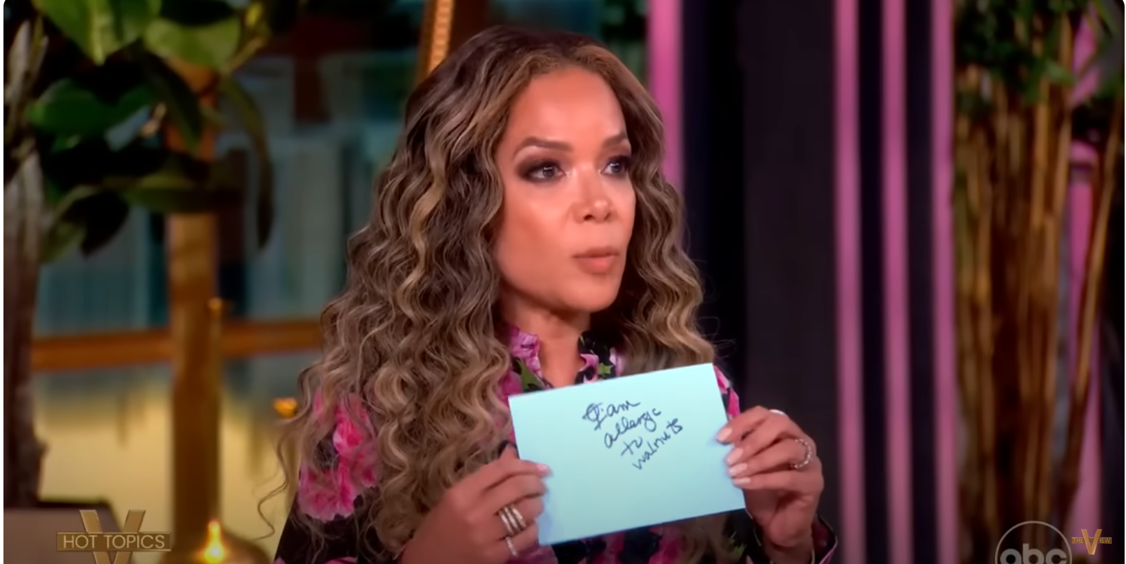 Sunny Hostin is holding up the note she passed to Alyssa that shows she's allergic to walnut, dated June 20, 2025 | Source: YouTube/TheView