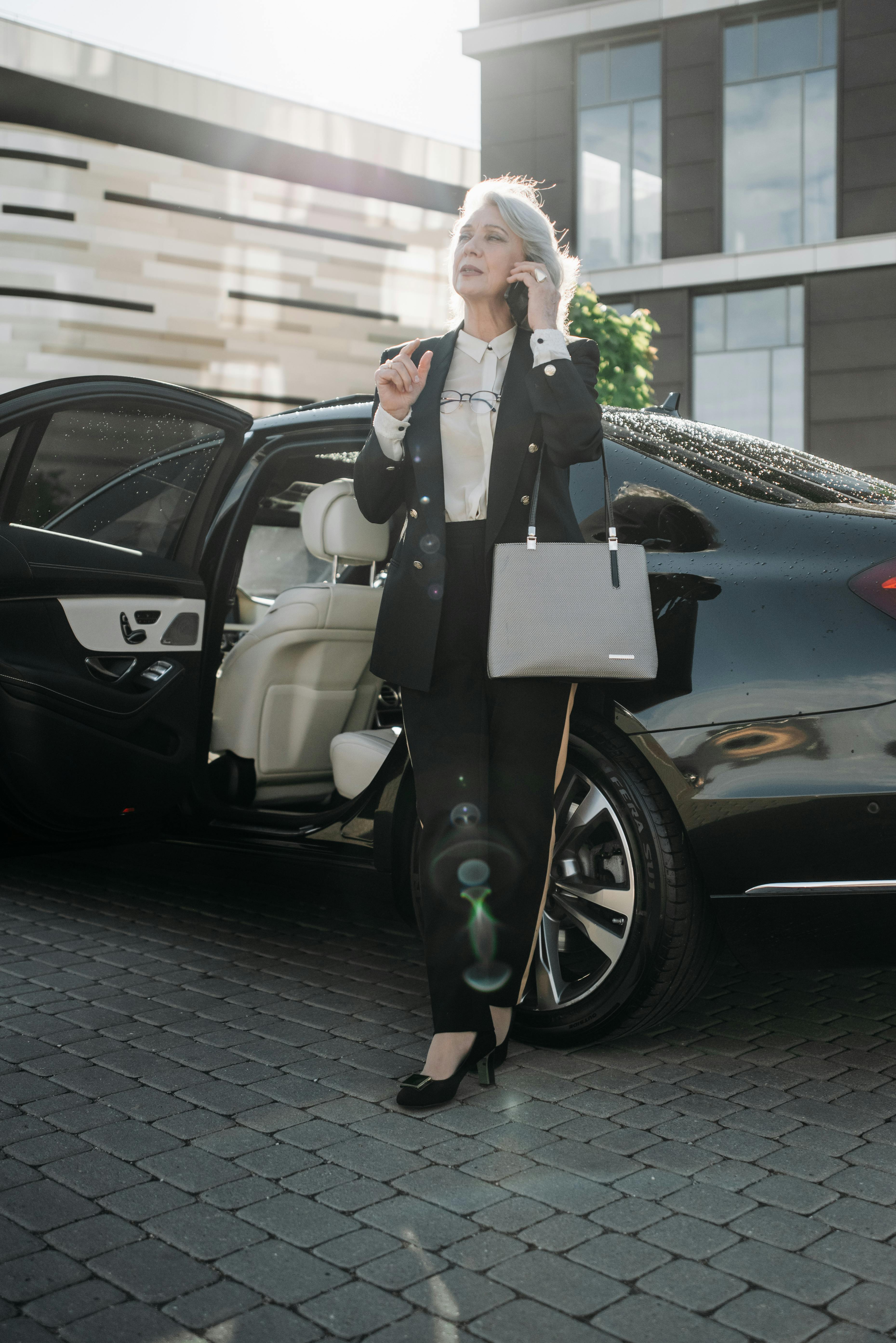 A woman standing next to an expensive car | Source: Pexels