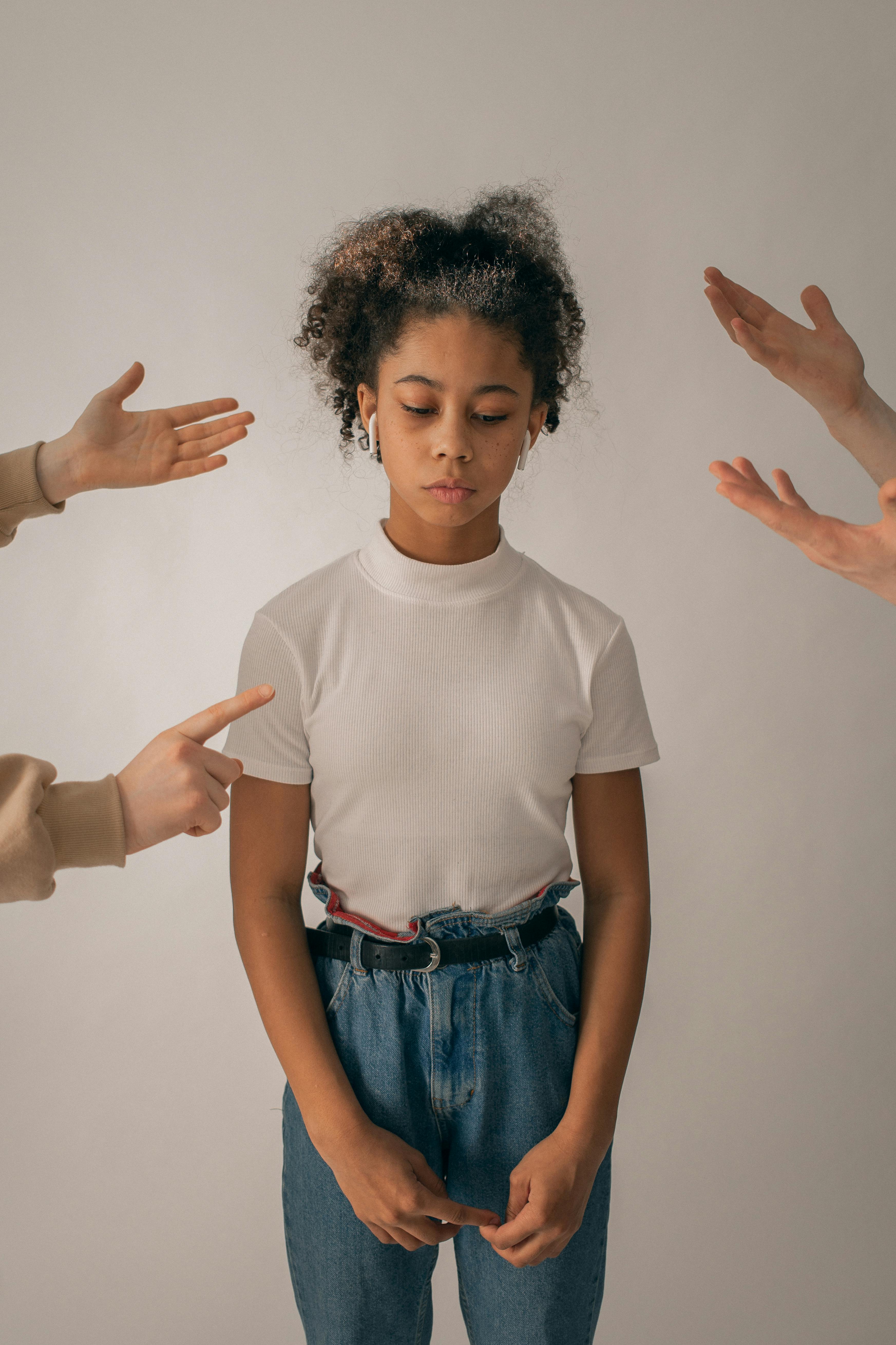 People gesturing while scolding a sad young girl | Source: Pexels