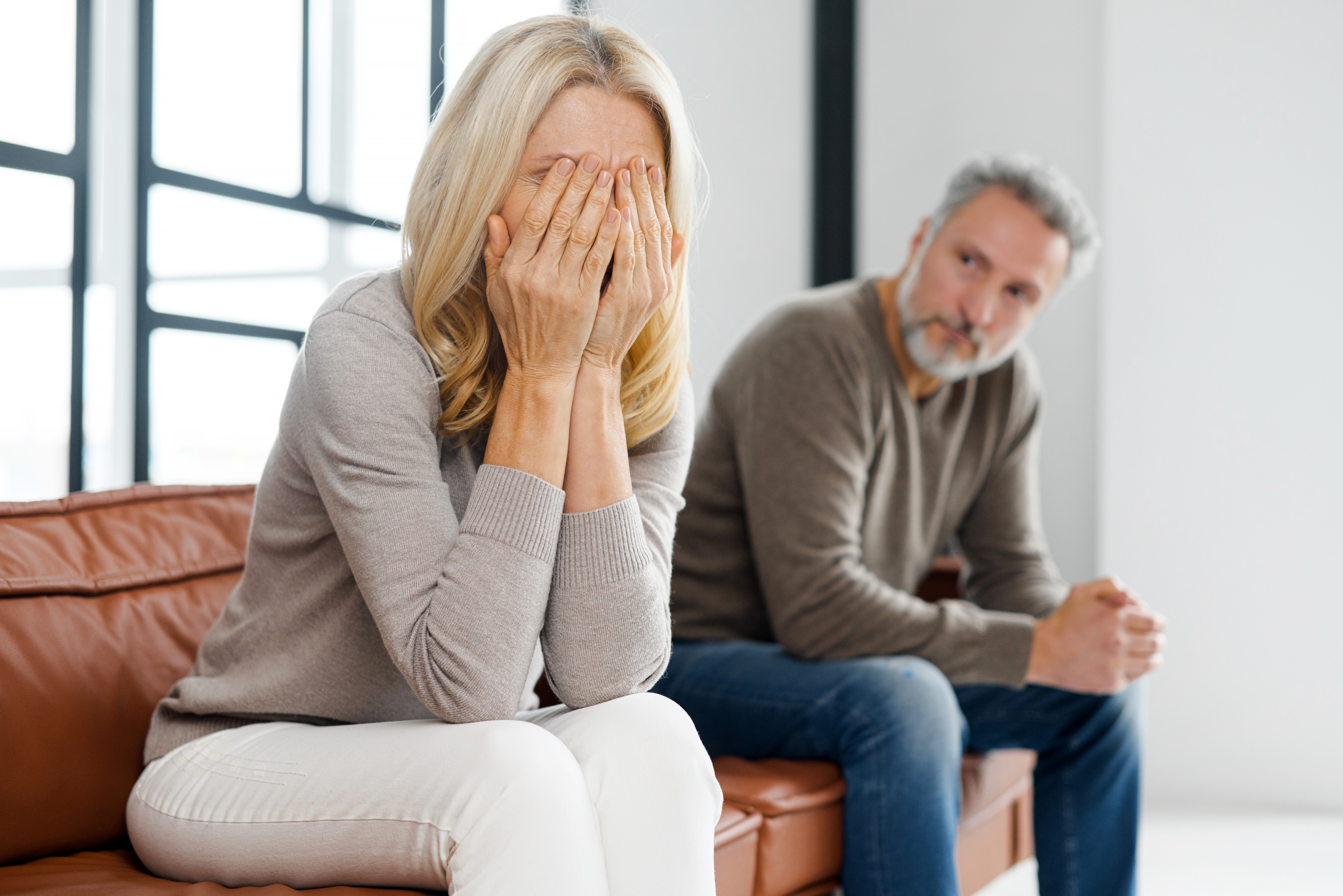 Upset middle-aged couple arguing at home | Source: Shutterstock