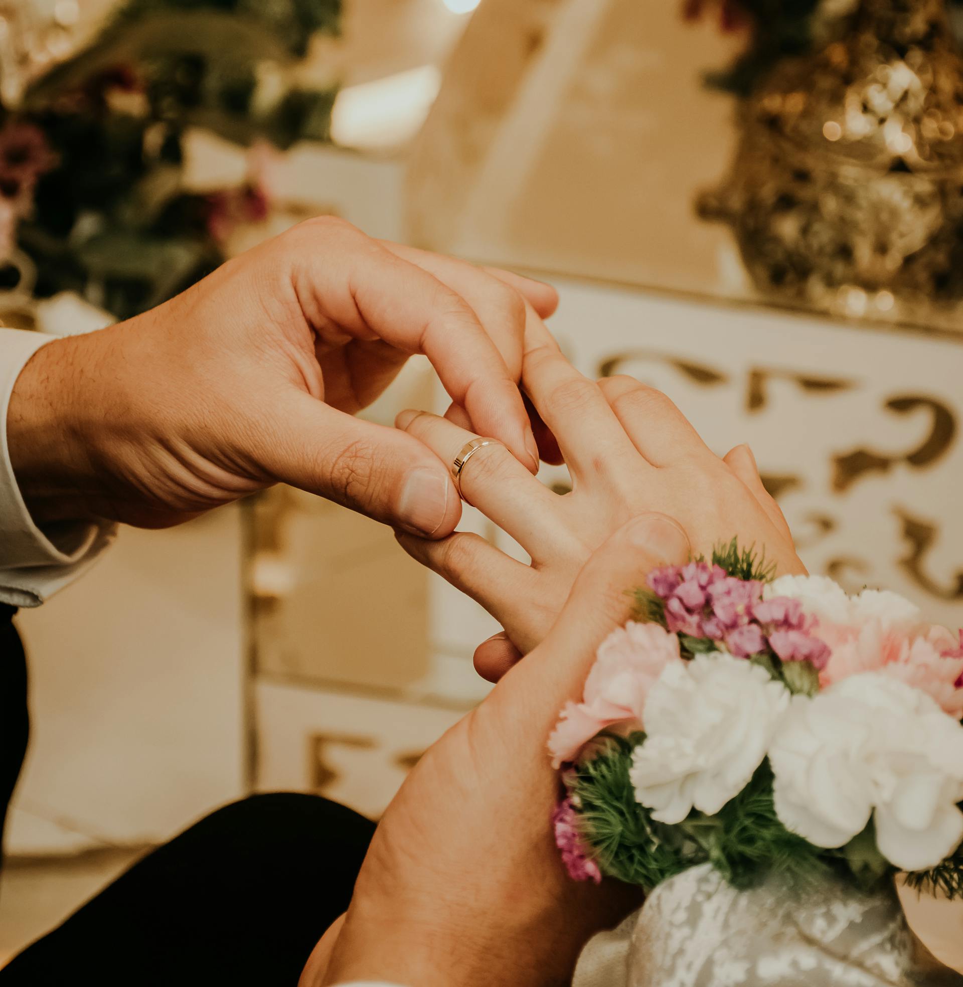A groom putting on the bride's ring | Source: Pexels