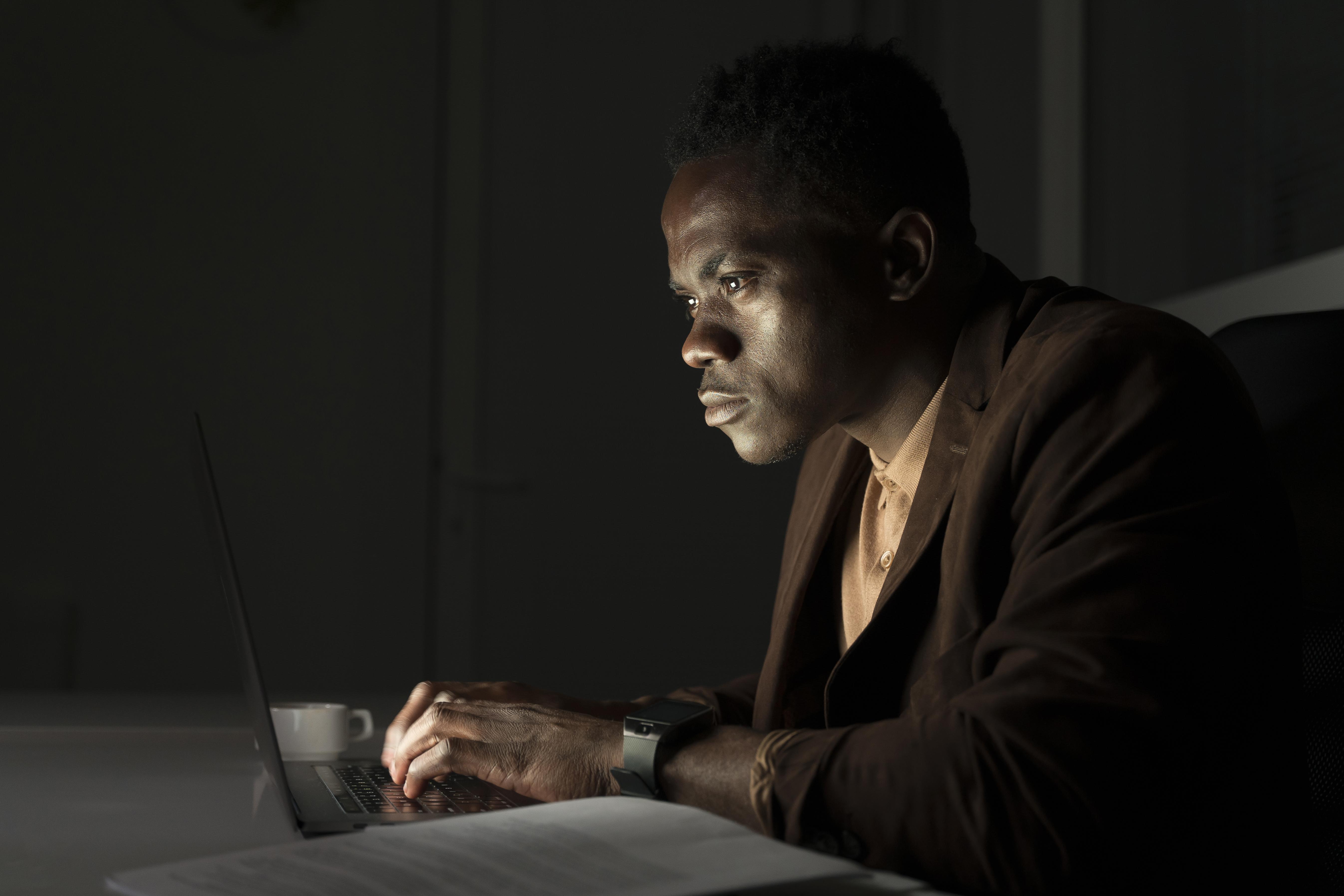 A man typing on his laptop | Source: Freepik