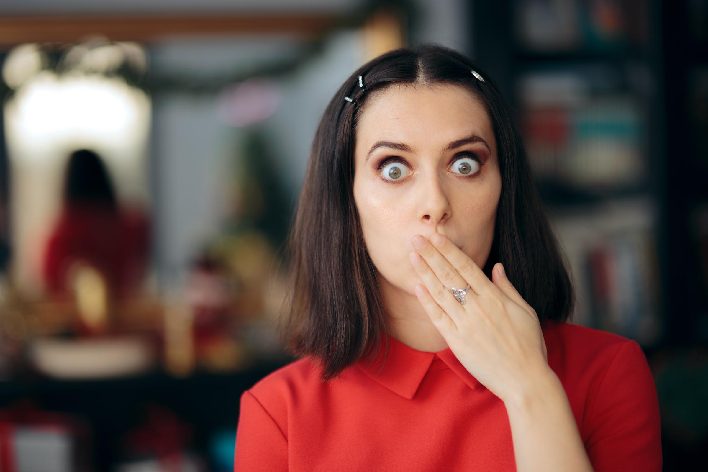 A woman covering her mouth after getting hiccups | Source: Getty Images