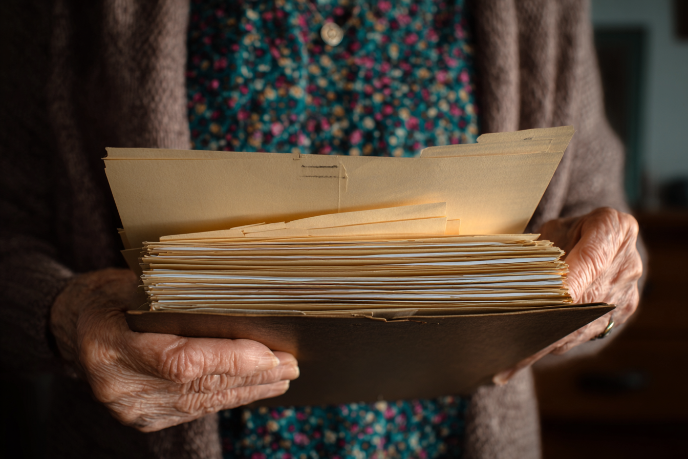 An older woman holding a folder | Source: Midjourney