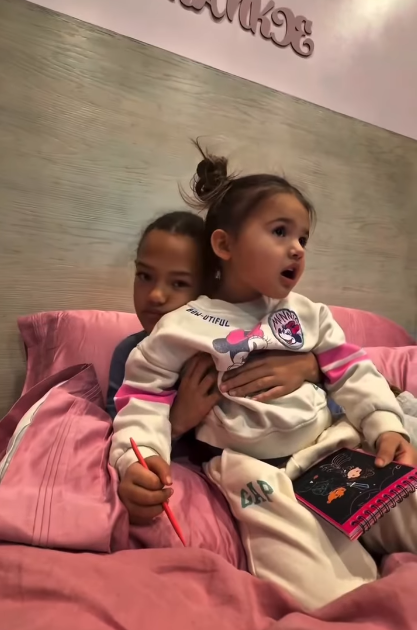 Shemar Moore's daughter, Frankie Moore, and Jesiree Dizon's daughter, Charli, hugging in a bed, from a video dated January 13, 2026 | Source: Instagram/shemarfmoore
