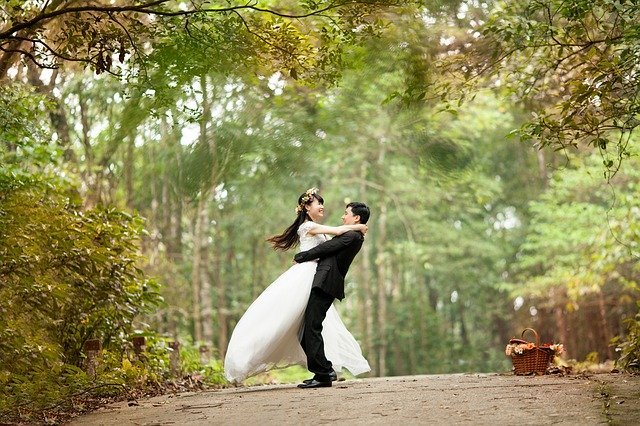 Braut und Bräutigam auf der Straße zwischen Bäumen | Quelle: Pixabay