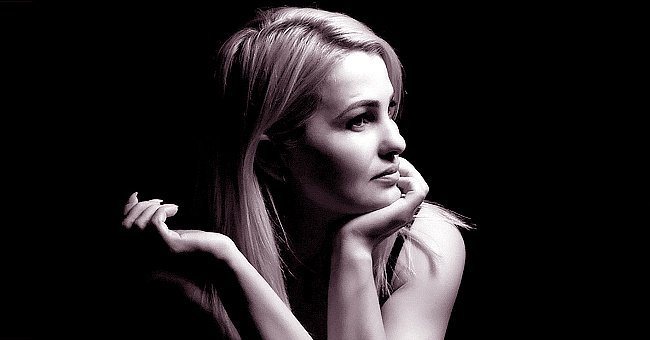 Close-up portrait of beautiful model with long blond hair on black background. | Source: Shutterstock