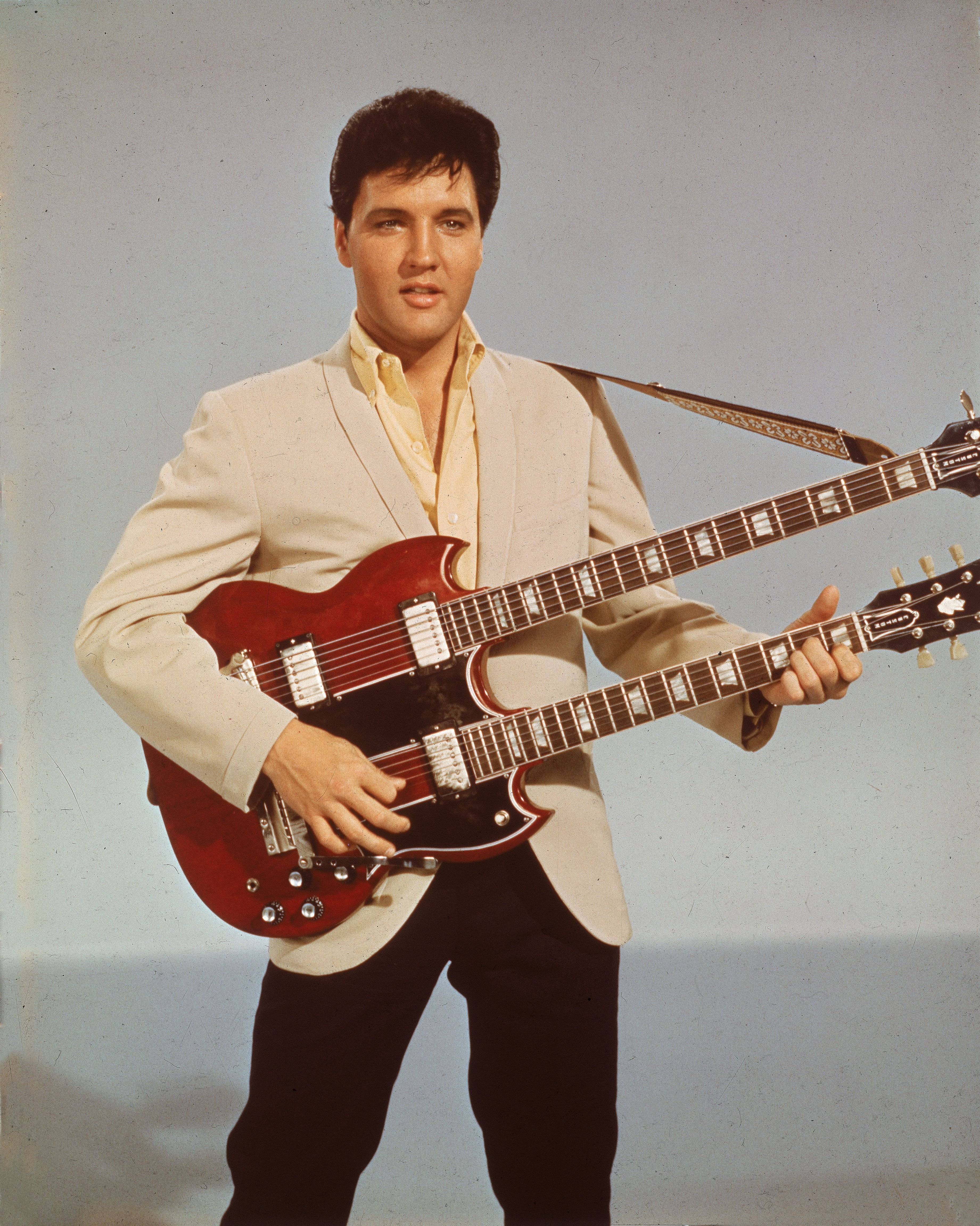 Elvis Presley (1935 - 1977) holding a 1965 Gibson EBS-1250 Double Bass. | Source: Getty Images