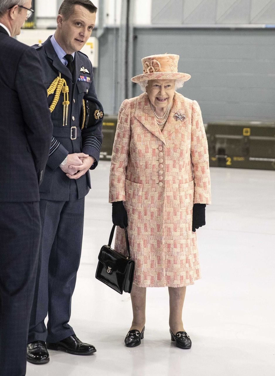  Queen Elizabeth II watches air crew at work on a training model F-35B Lightning II fighter. | Source: Getty Images