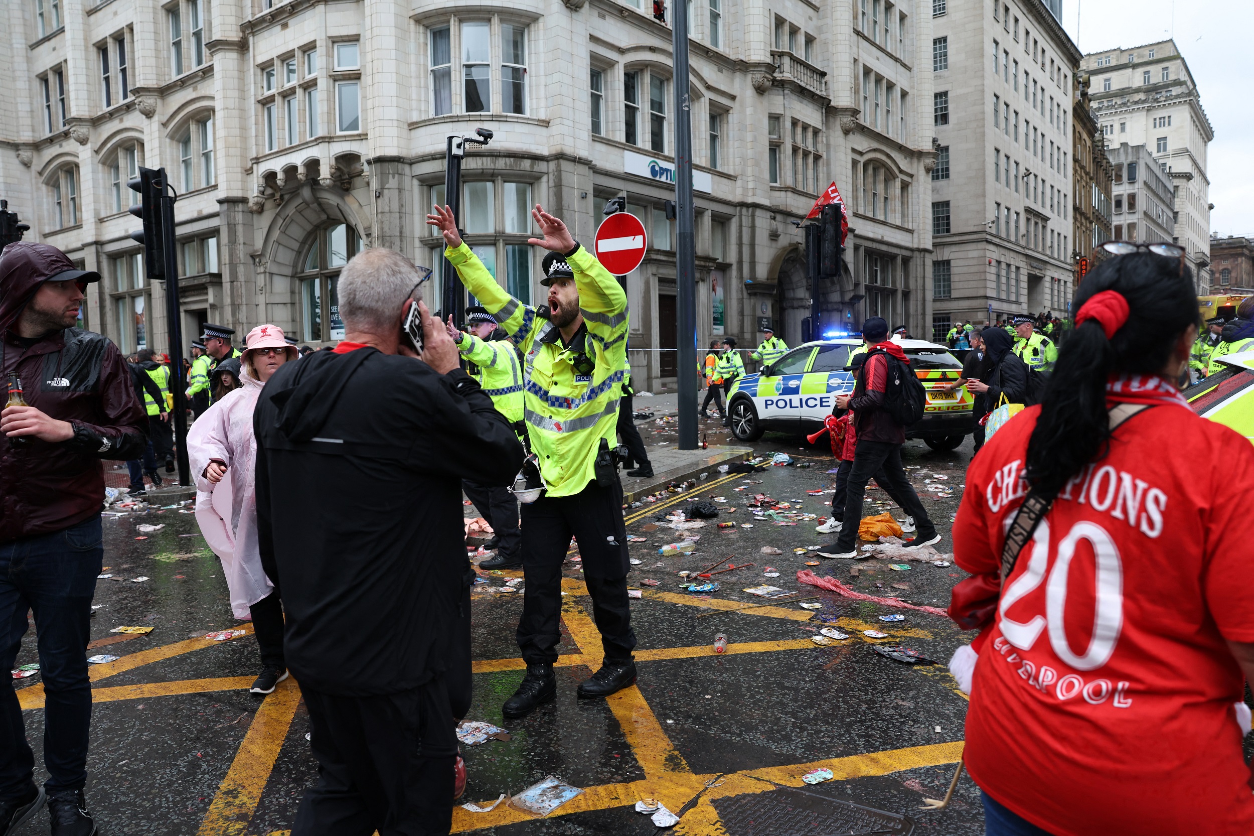 A police officer shouts at Liverpool fans while on duty at a police cordon at the entrance to Water Street, during an open-top bus victory parade for Liverpool's Premier League title win, in Liverpool, north-west England on May 26, 2025 | Source: Getty Images
