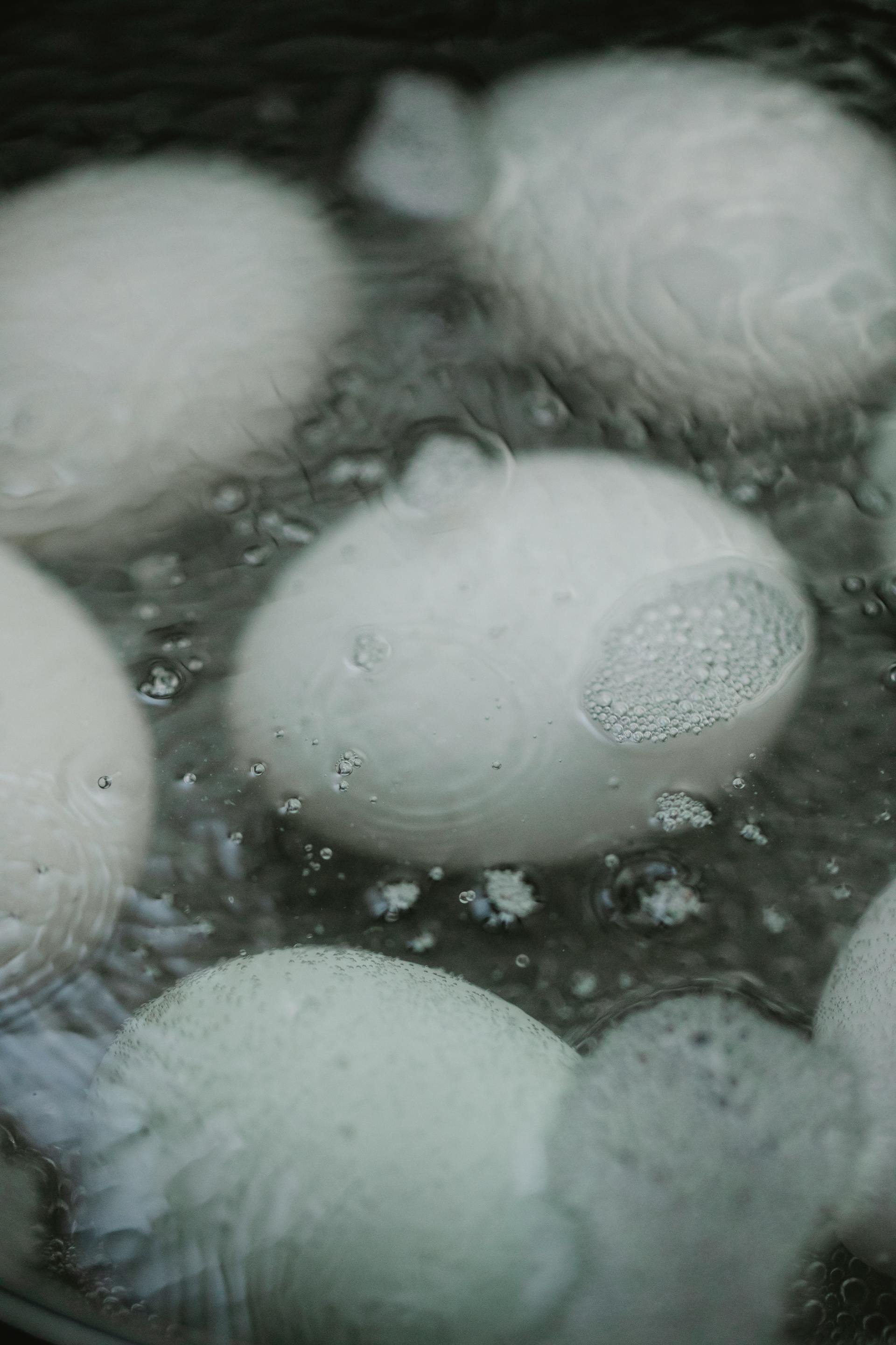 A closeup of white eggs in boiling water | Source: Pexels