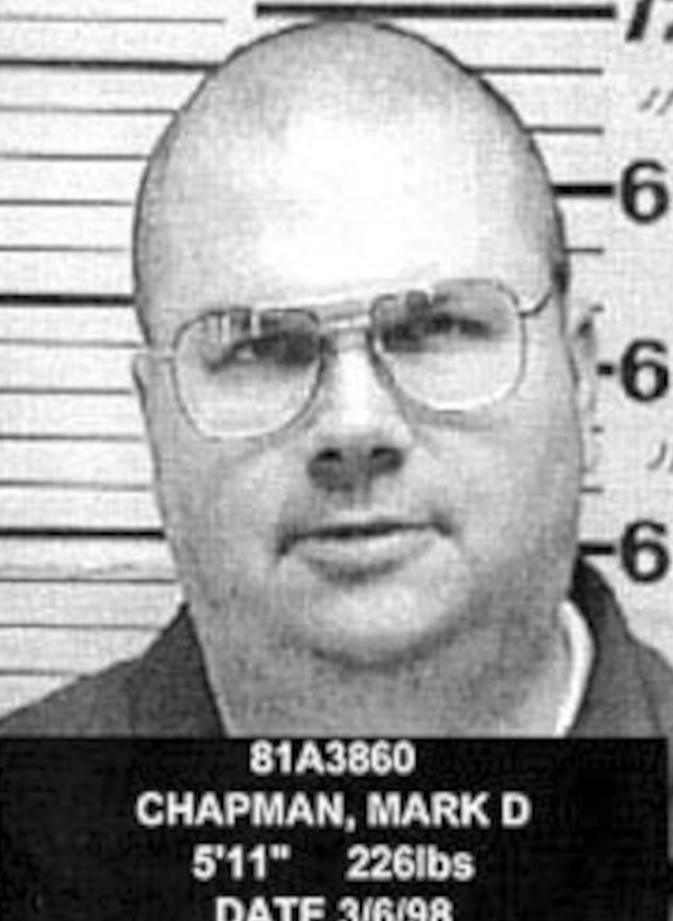 Mark David Chapman in a mug shot at the New York State Department of Correctional Services, US, March 1998. | Source: Getty Images.
