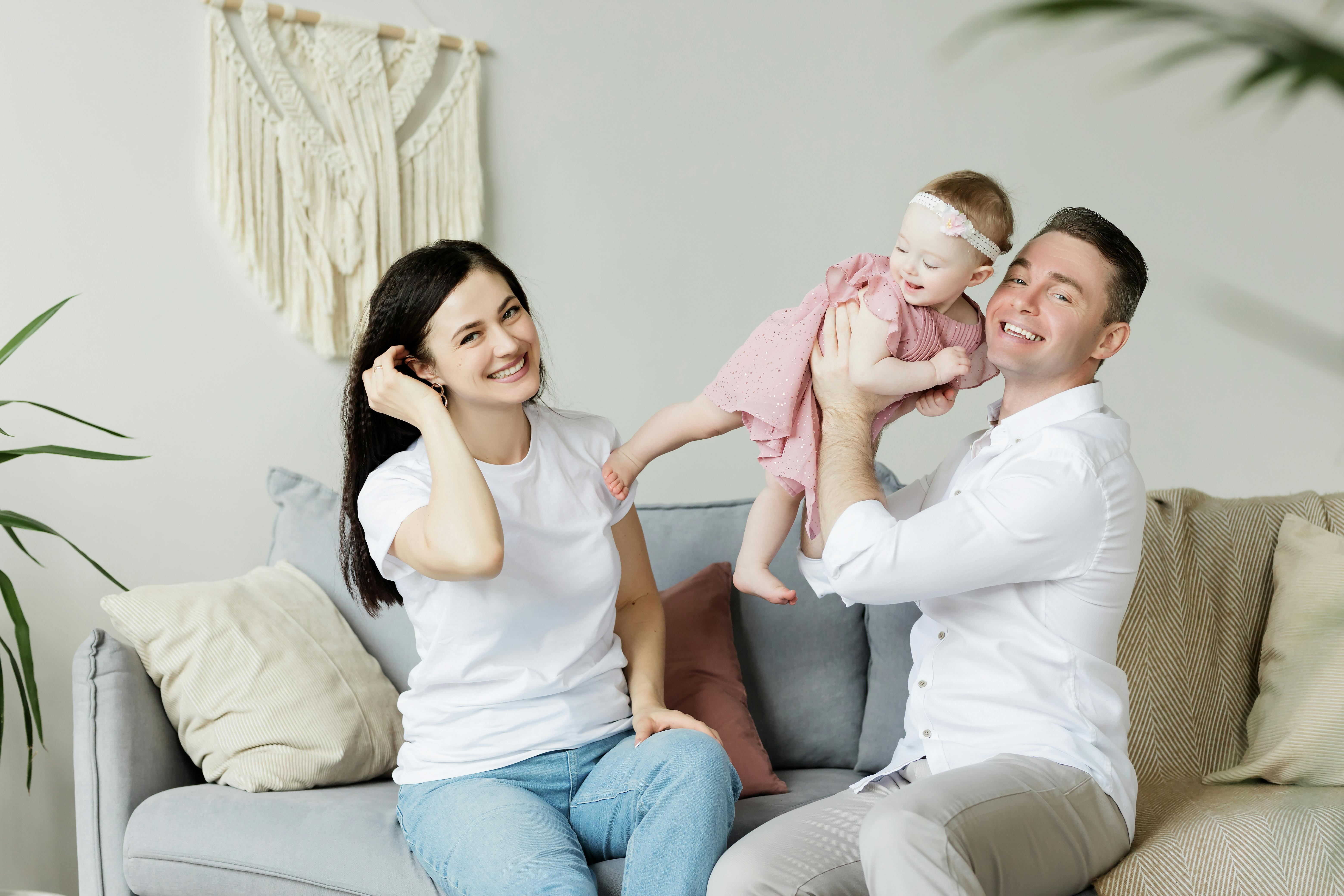 A happy couple playing with their daughter | Source: Pexels