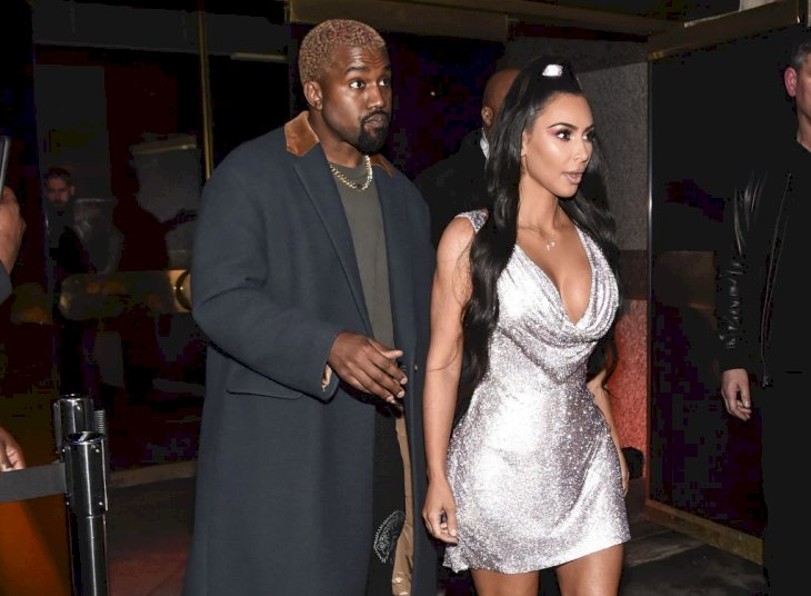 Kim Kardashian is seen wearing a Versace dress with Kanye West outside the Versace Pre-Fall 2019 Collection on December 2, 2018 in New York City. | Photo by Daniel Zuchnik/Getty Images