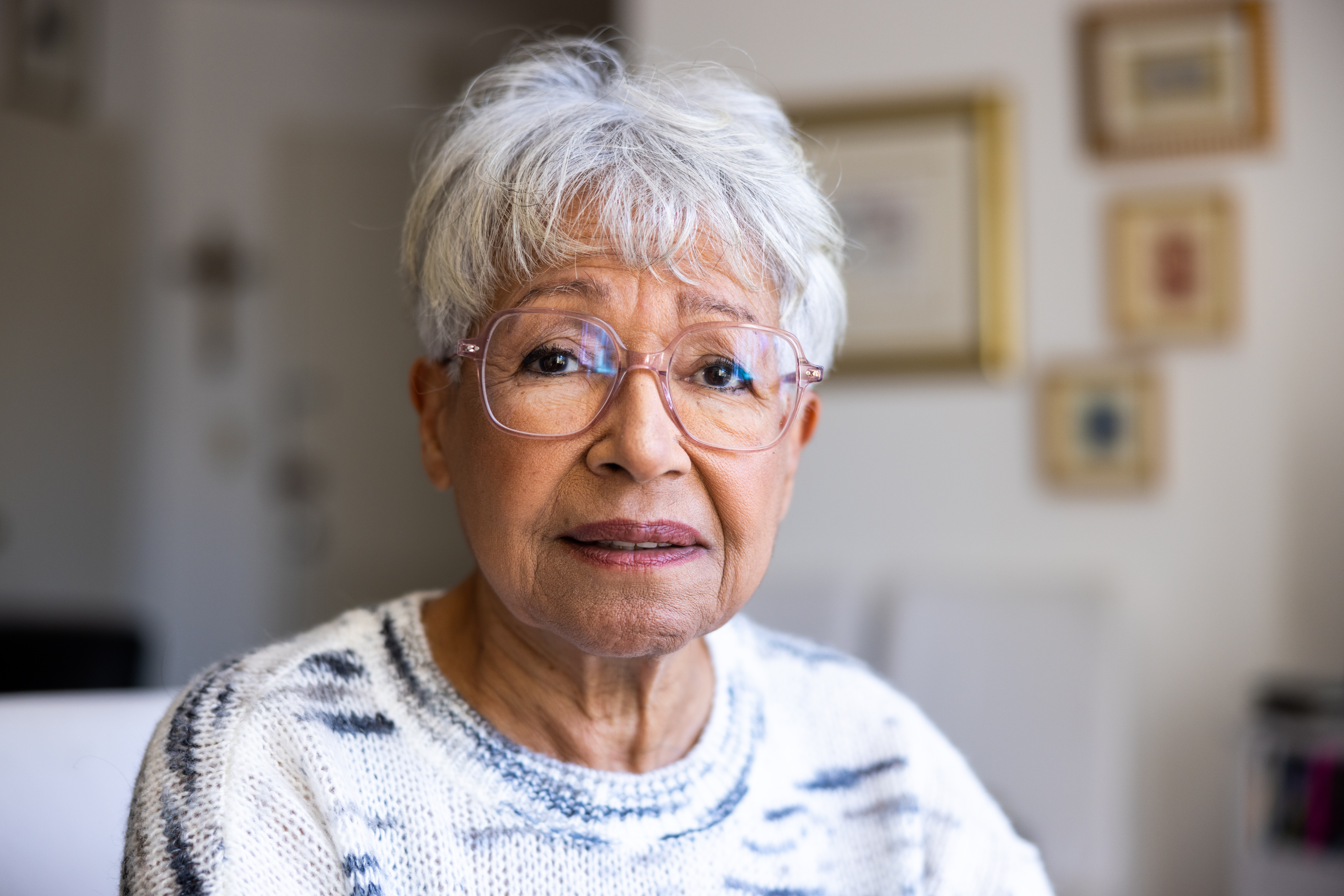 Portrait of a beautiful mixed race senior woman in her home | Source: Getty Images