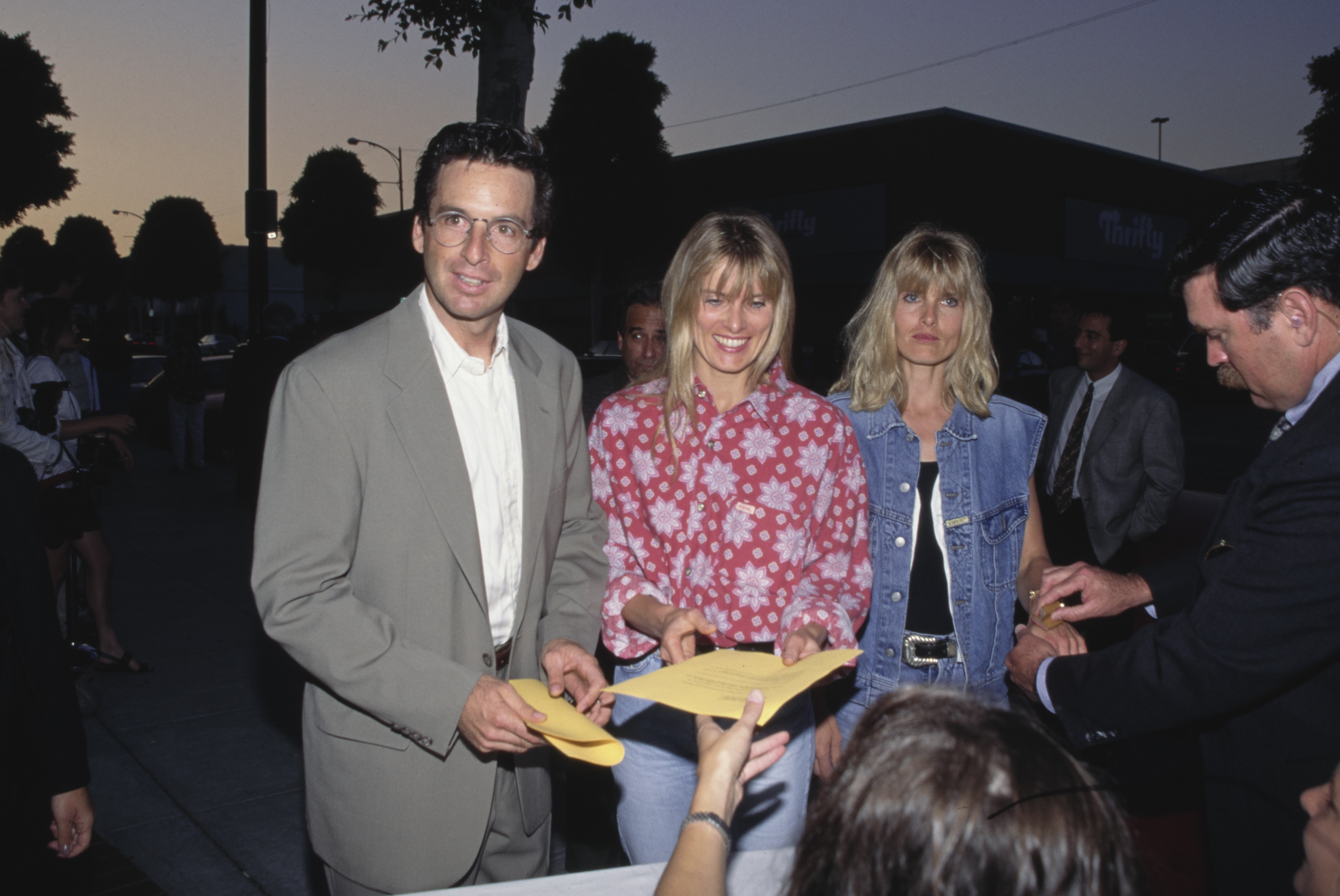 Robert Carradine, Edie Mani, and a guest attend the grand opening party for Grand Havana Room at Canon Restaurant on July 13, 1995, in Beverly Hills, California | Source: Getty Images