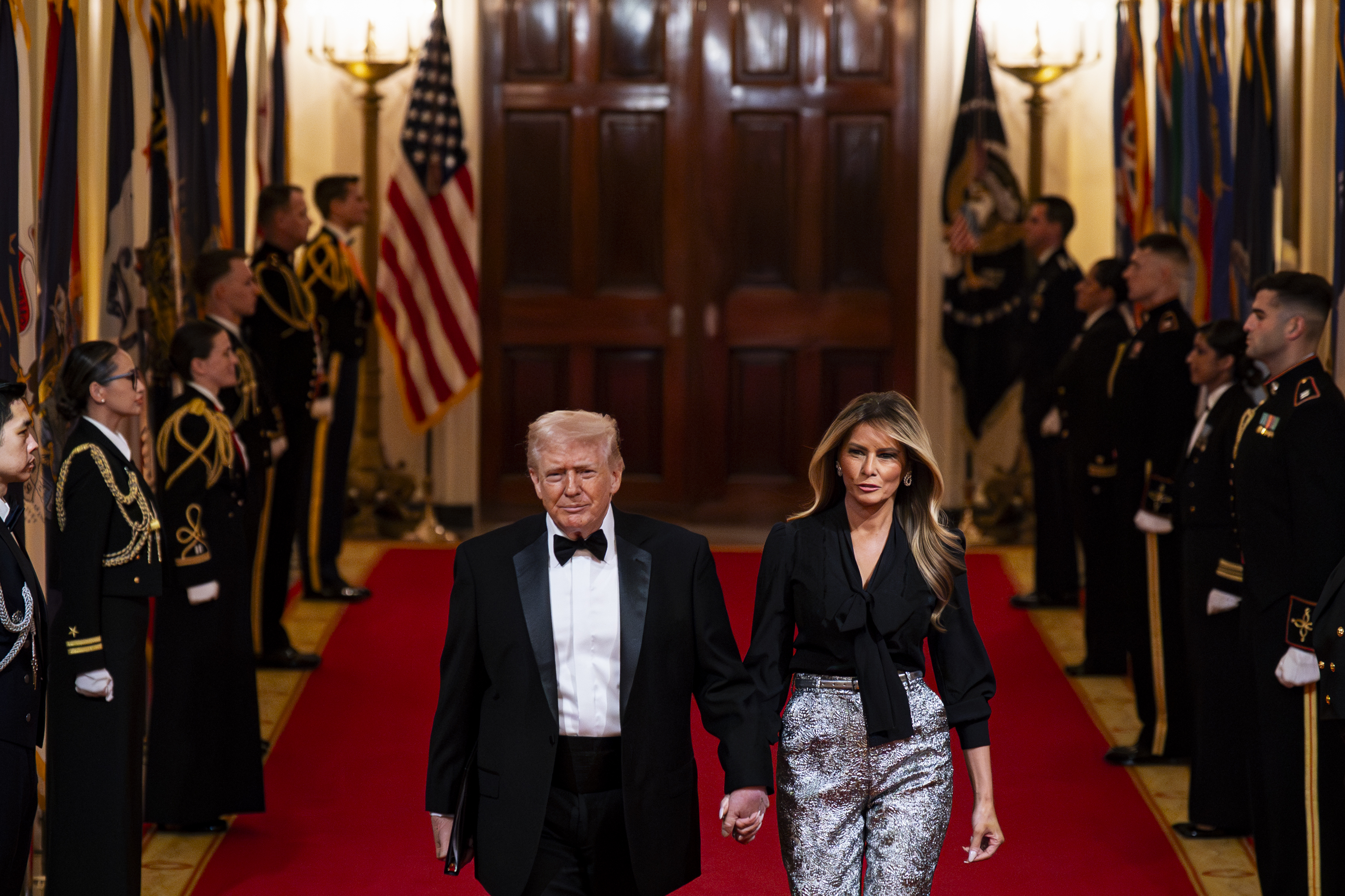 Donald Trump and Melania Trump arrive during the National Governors Association Evening Dinner and Reception in the East Room of the White House on February 21, 2026, in Washington, DC | Source: Getty Images