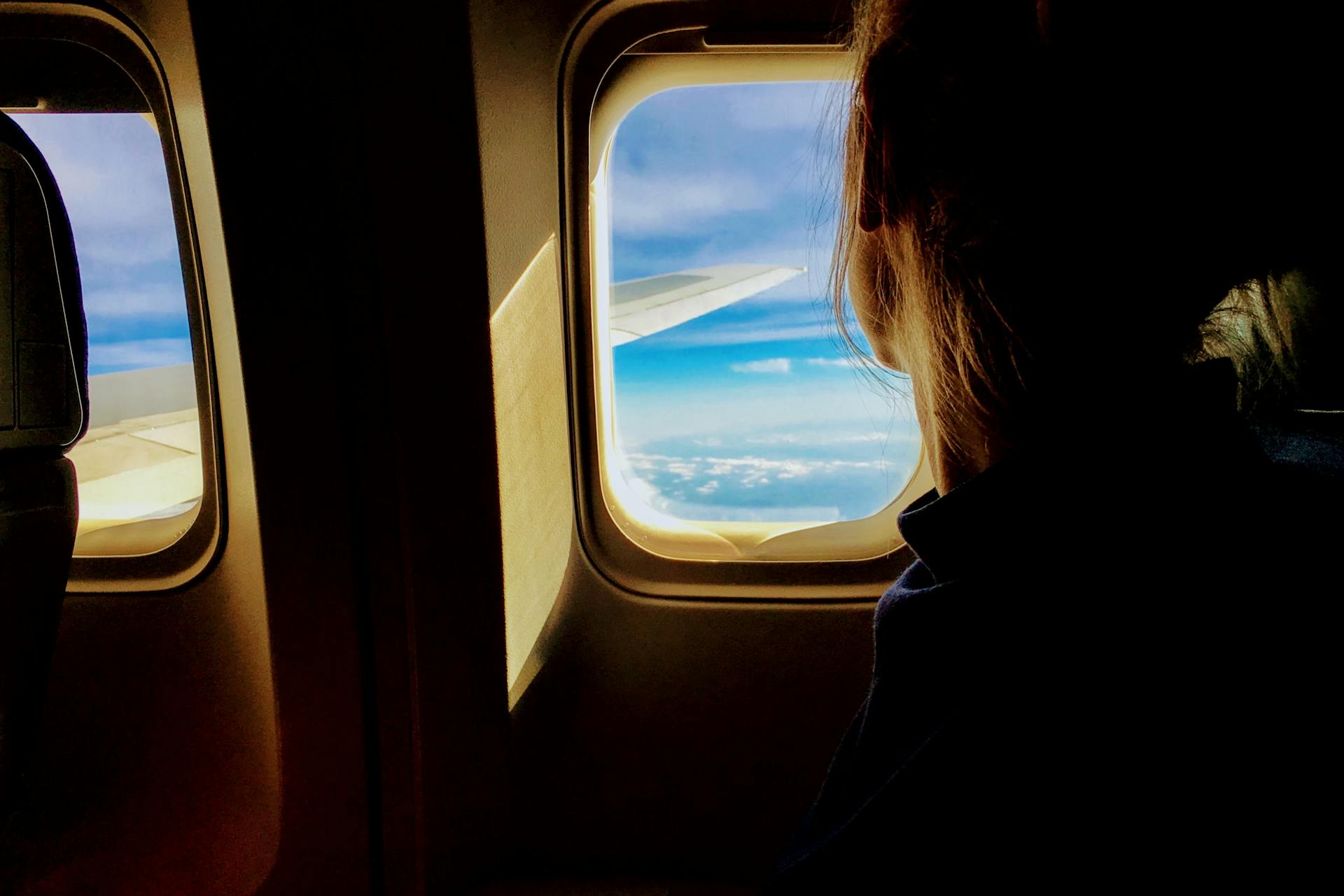 A woman riding in an airplane | Source: Pexels