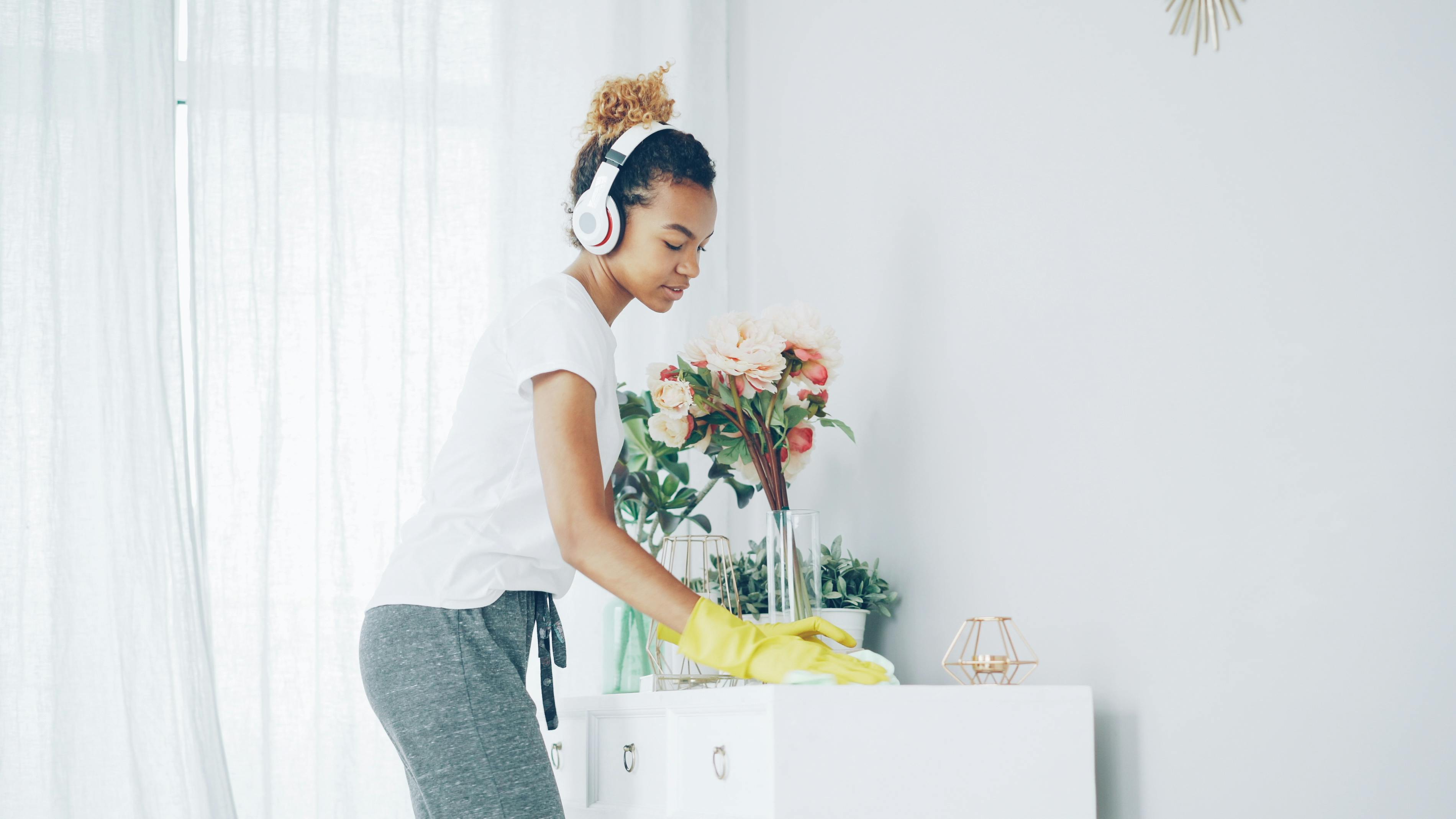 A woman cleaning her living room furniture | Source: Pexels