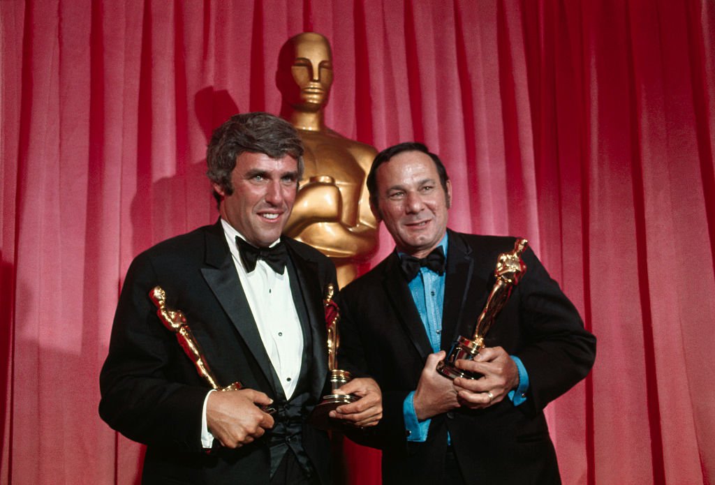 For "Best Song in a Movie" for 1969, composer Burt Bacharach (left) and lyricist Hal David hold Oscars they won for "Raindrops Keep Falling on my Head" from "Butch Cassidy and the Sundance Kid," at the Academy Awards. | Source: Getty Images