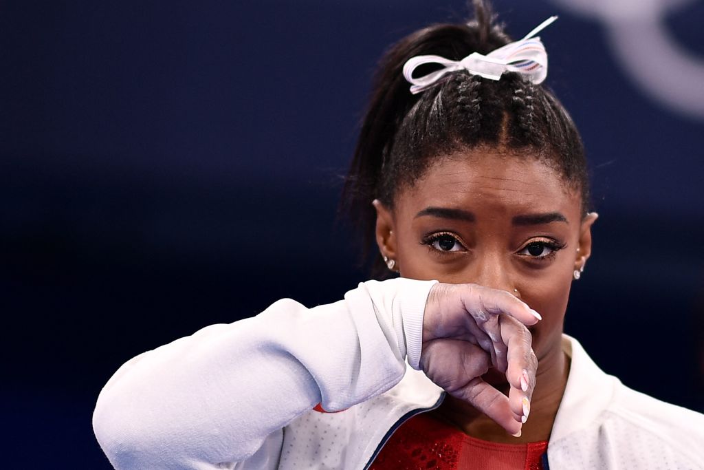 Simone Biles gestures during the artistic gymnastics women's team final during the Tokyo 2020 Olympic Games at the Ariake Gymnastics Centre, in Tokyo, on July 27, 2021. | Source: Getty Images